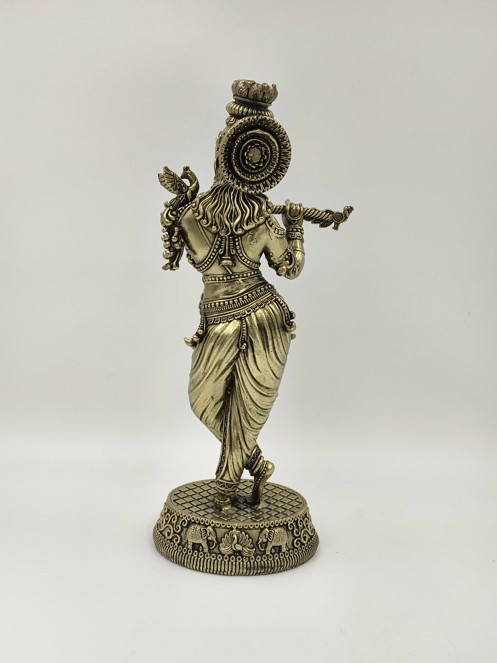 Back view of large brass Venumadhava Krishna statue playing flute