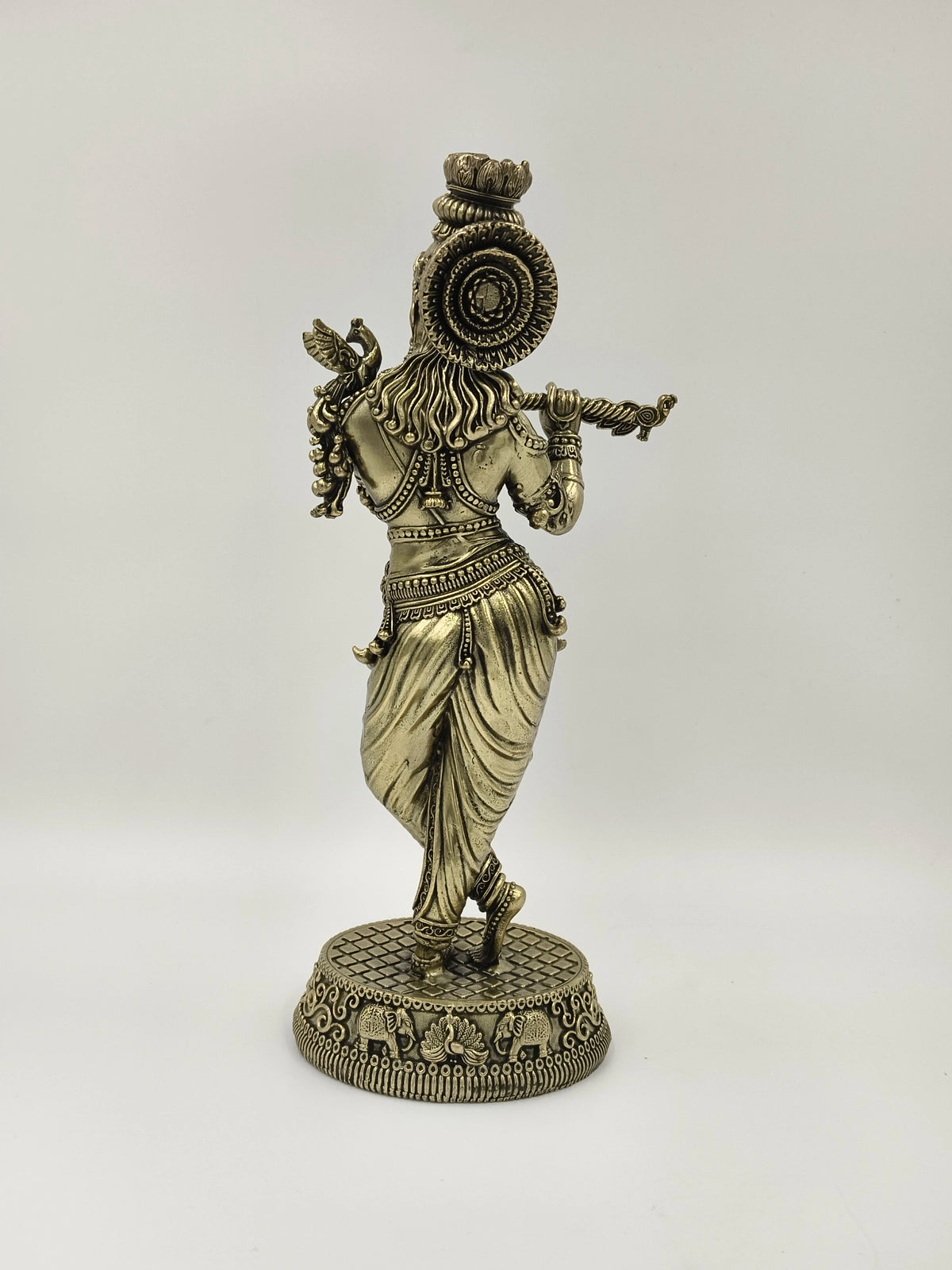 Back view of large brass Venumadhava Krishna statue playing flute