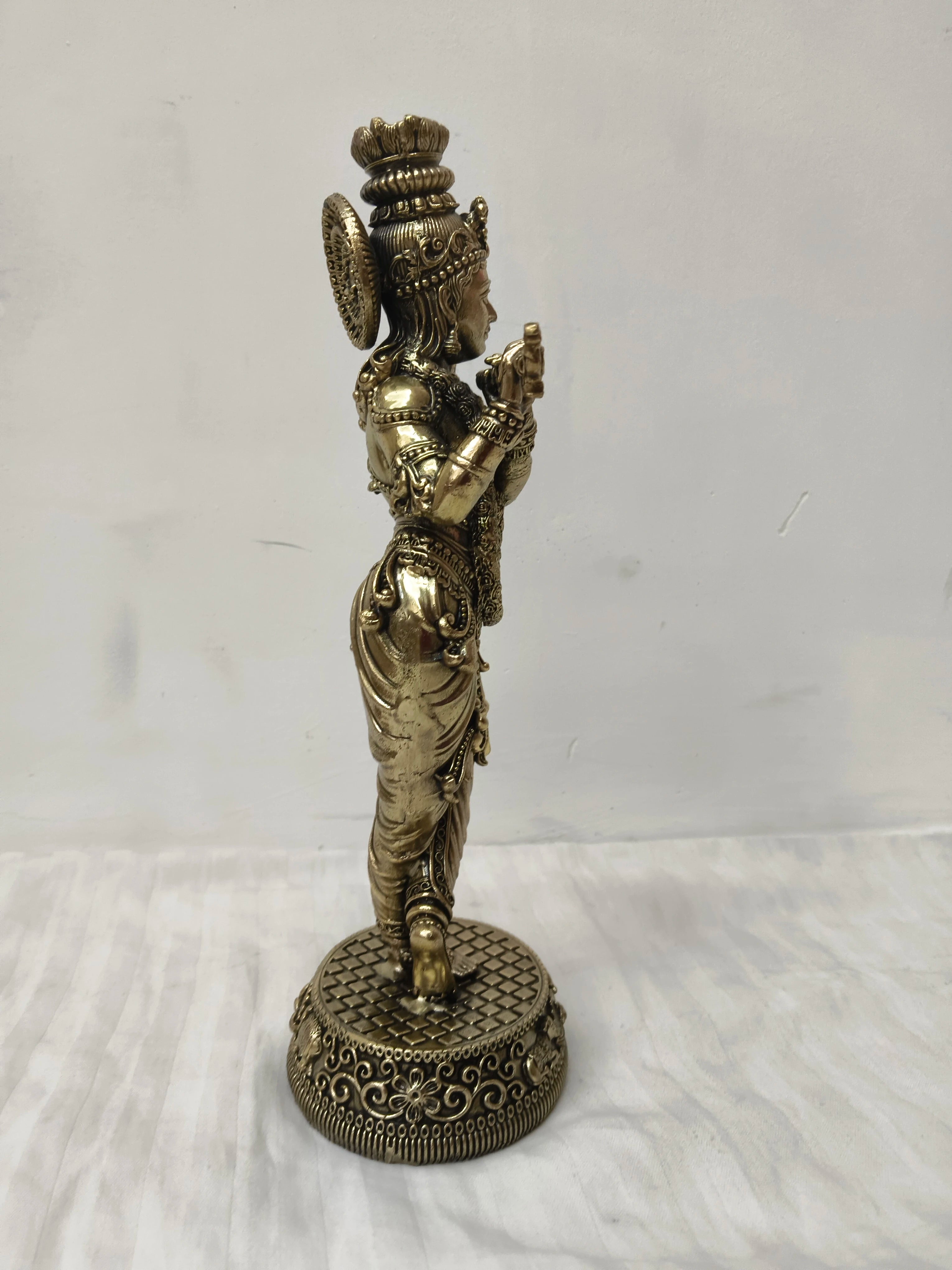 Side view of large brass Venumadhava Krishna statue standing on decorative base