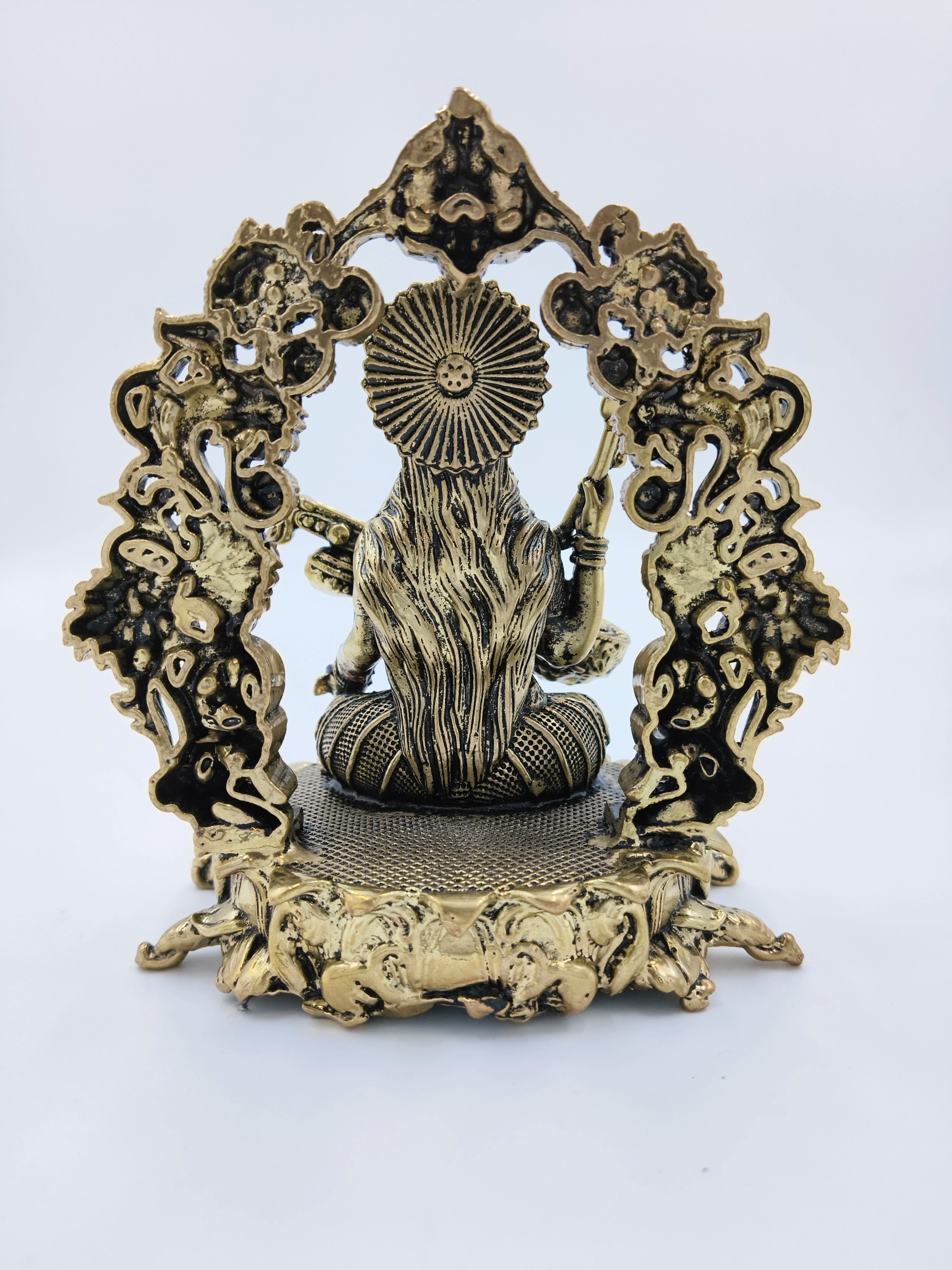 Rear view of medium brass Vagdevi Kalamurti sculpture depicting goddess Saraswathi