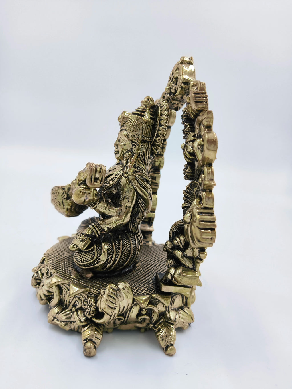 Side view of medium brass Vagdevi Kalamurti sculpture of Saraswathi deity