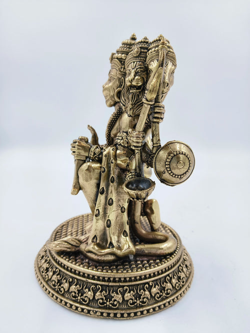 Side view of brass Pancavaktra Mahaveer idol with five heads and intricate base