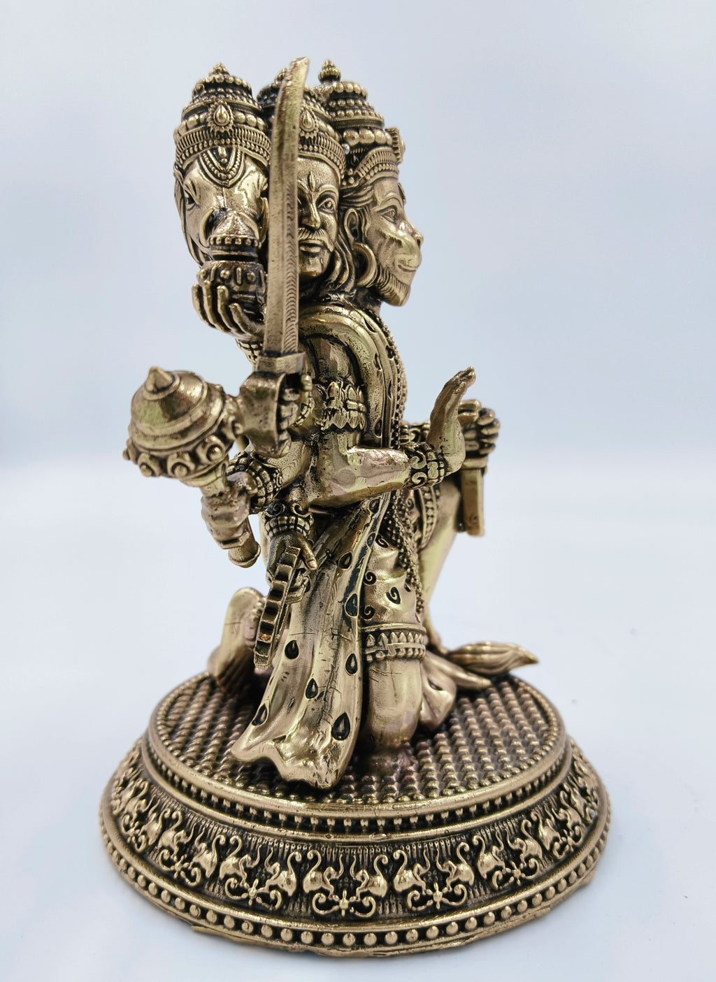 Side view of a medium brass Pancavaktra Mahaveer Hanuman idol with intricate details