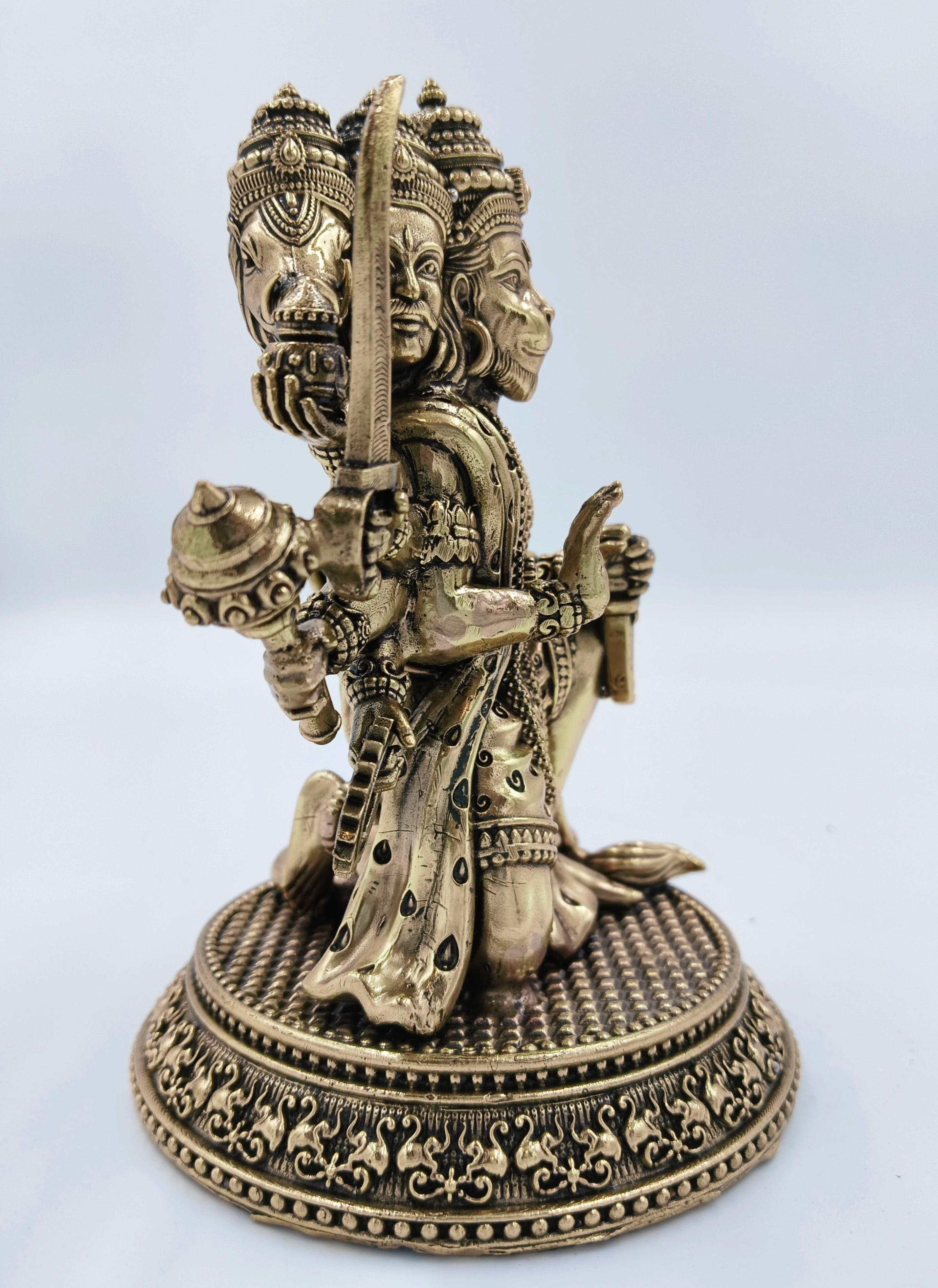 Side view of a medium brass Pancavaktra Mahaveer Hanuman idol with intricate details