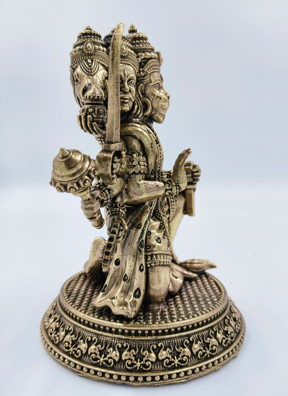 Side view of a medium brass Pancavaktra Mahaveer Hanuman idol with intricate details