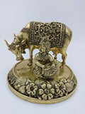 Brass statue of Krishna as child Gau Gopal with cow on floral base