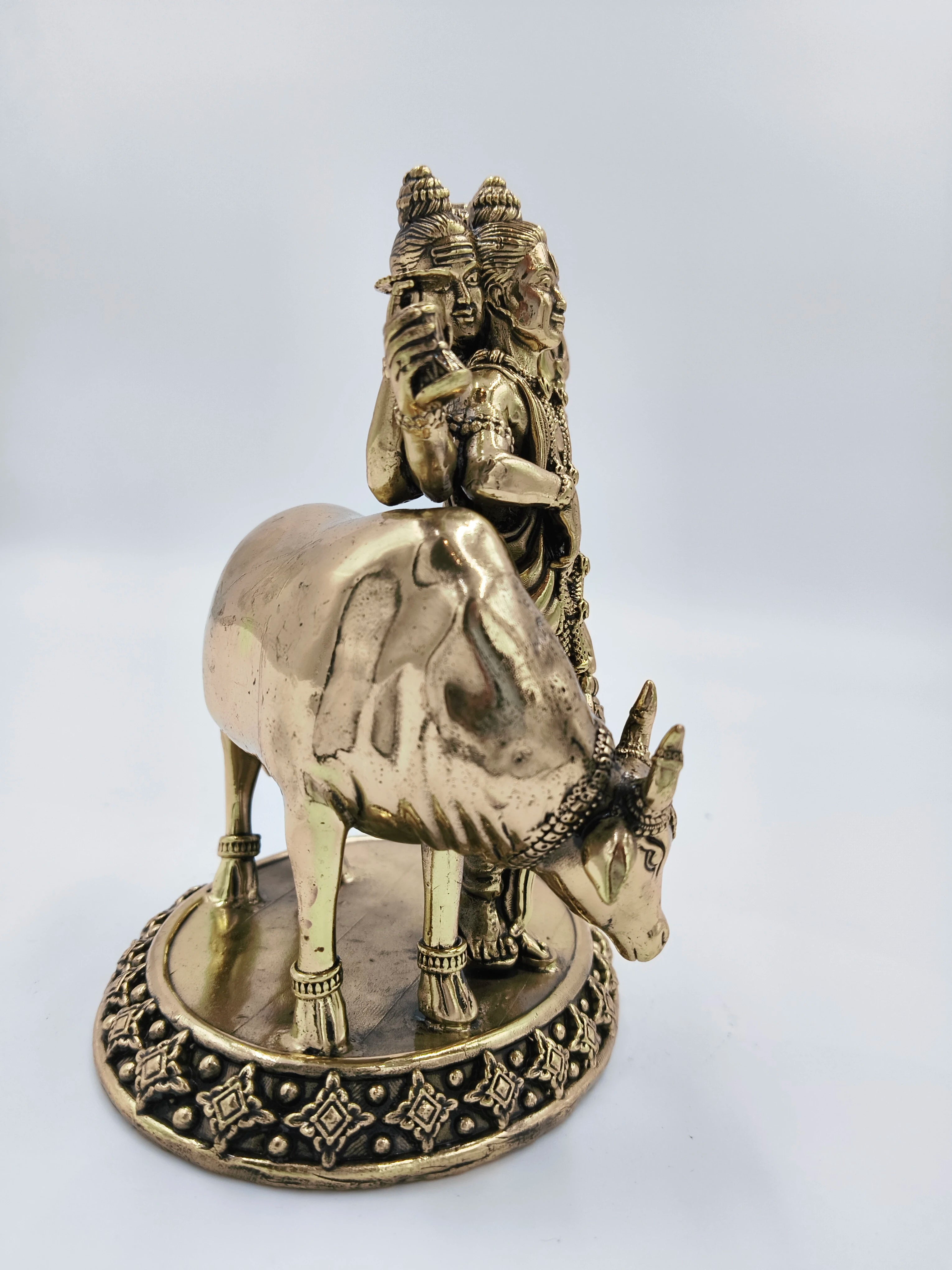 Medium brass statue of Dattatreya deity with sacred cow on decorative base