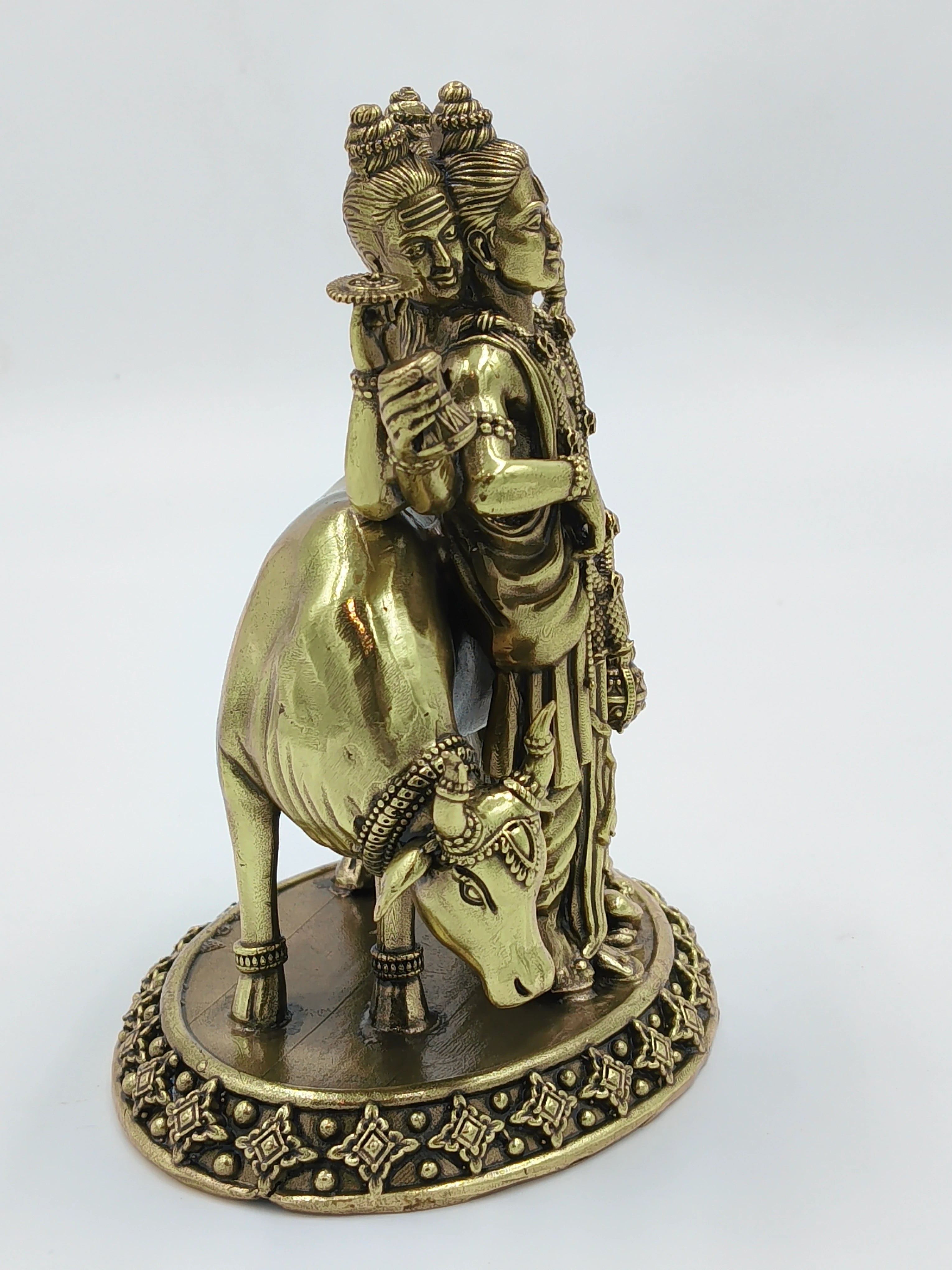 Brass sculpture of deity Dattatreya with cow on decorative base