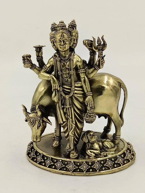Medium brass Dattatreya statue with three heads, six arms, cow, and dog on decorative base