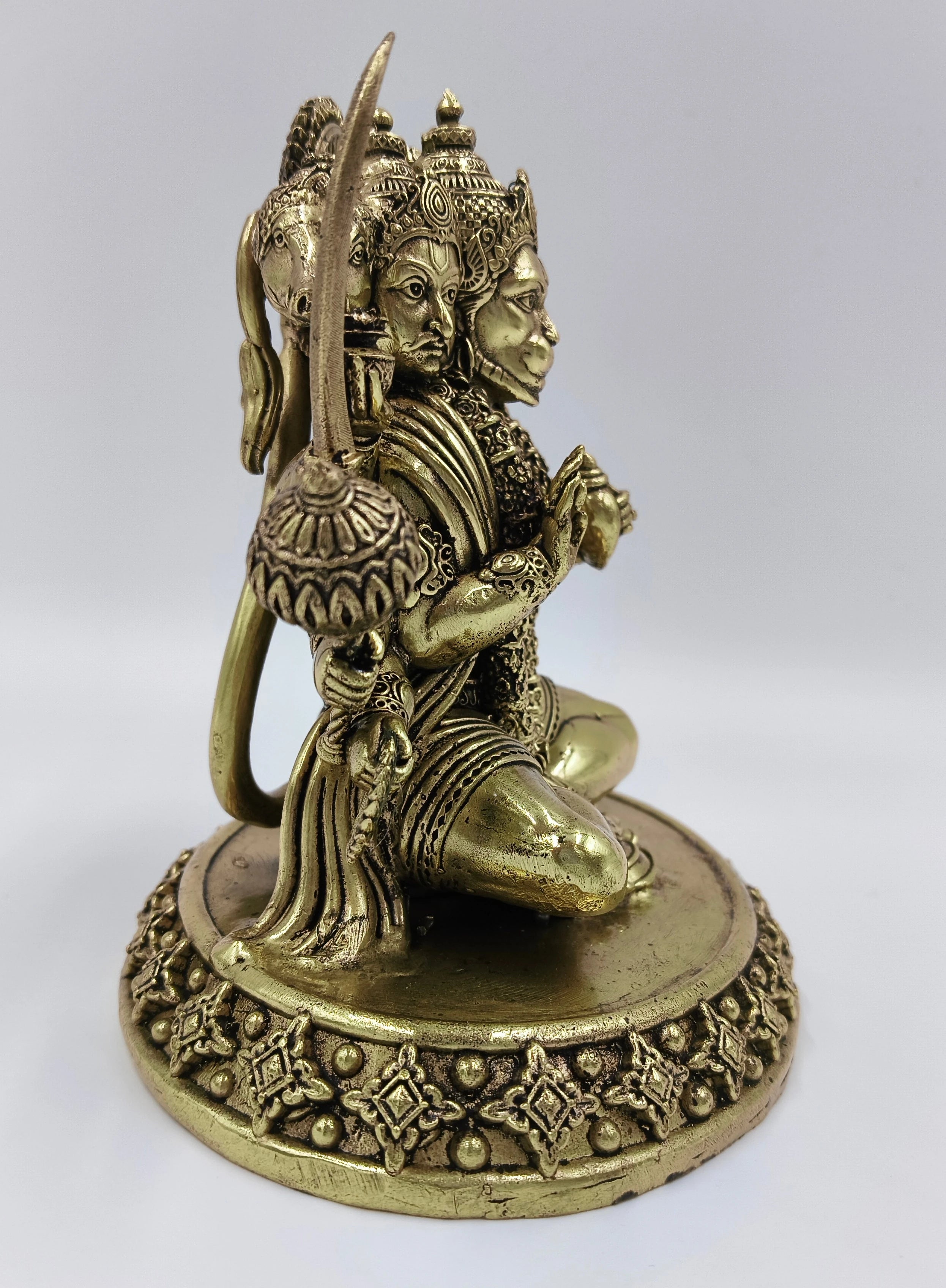Side view of brass Panchamukhi Hanuman idol with five faces and detailed base