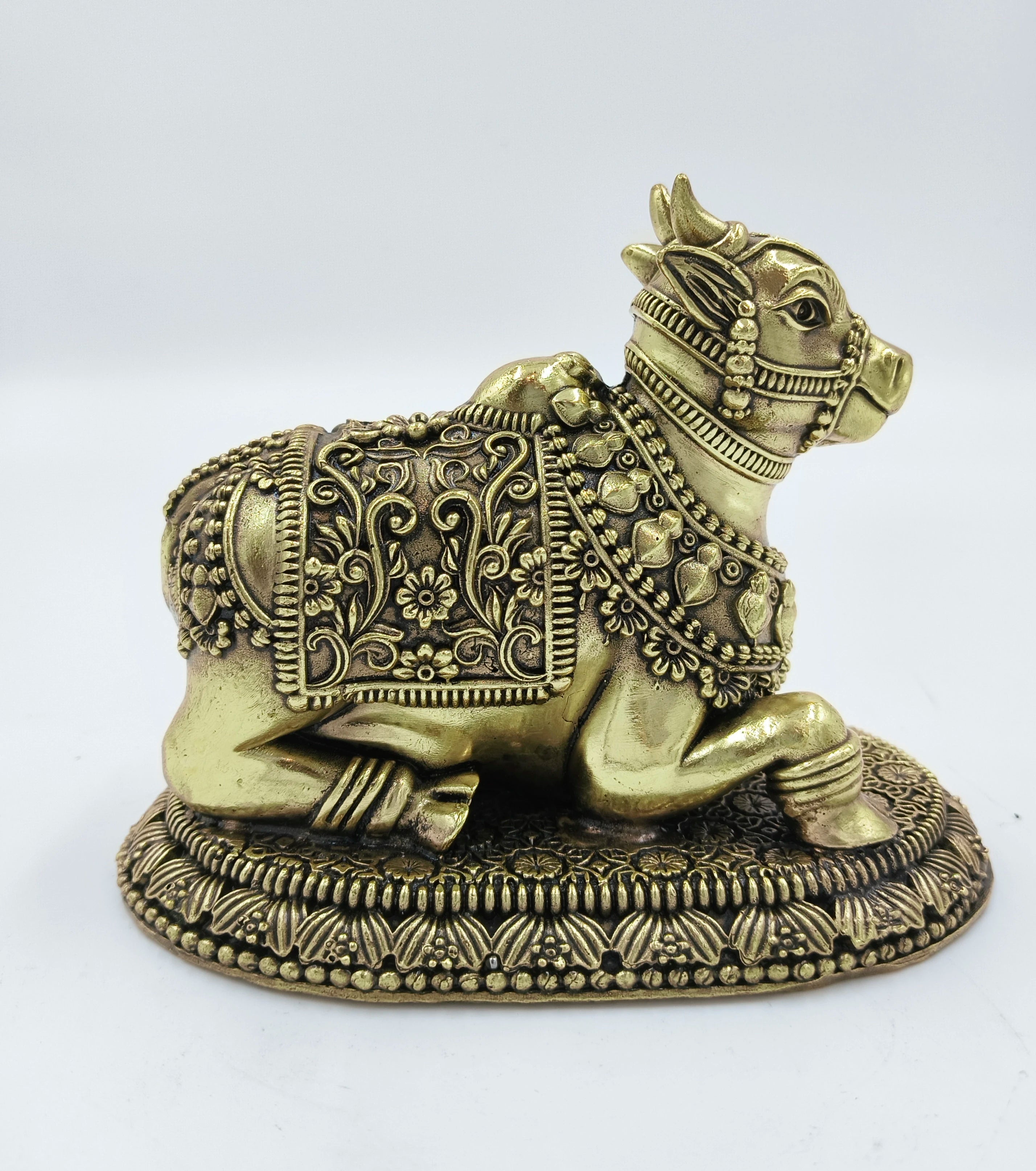Brass Nandikeshwara sculpture with detailed floral engravings on base and body