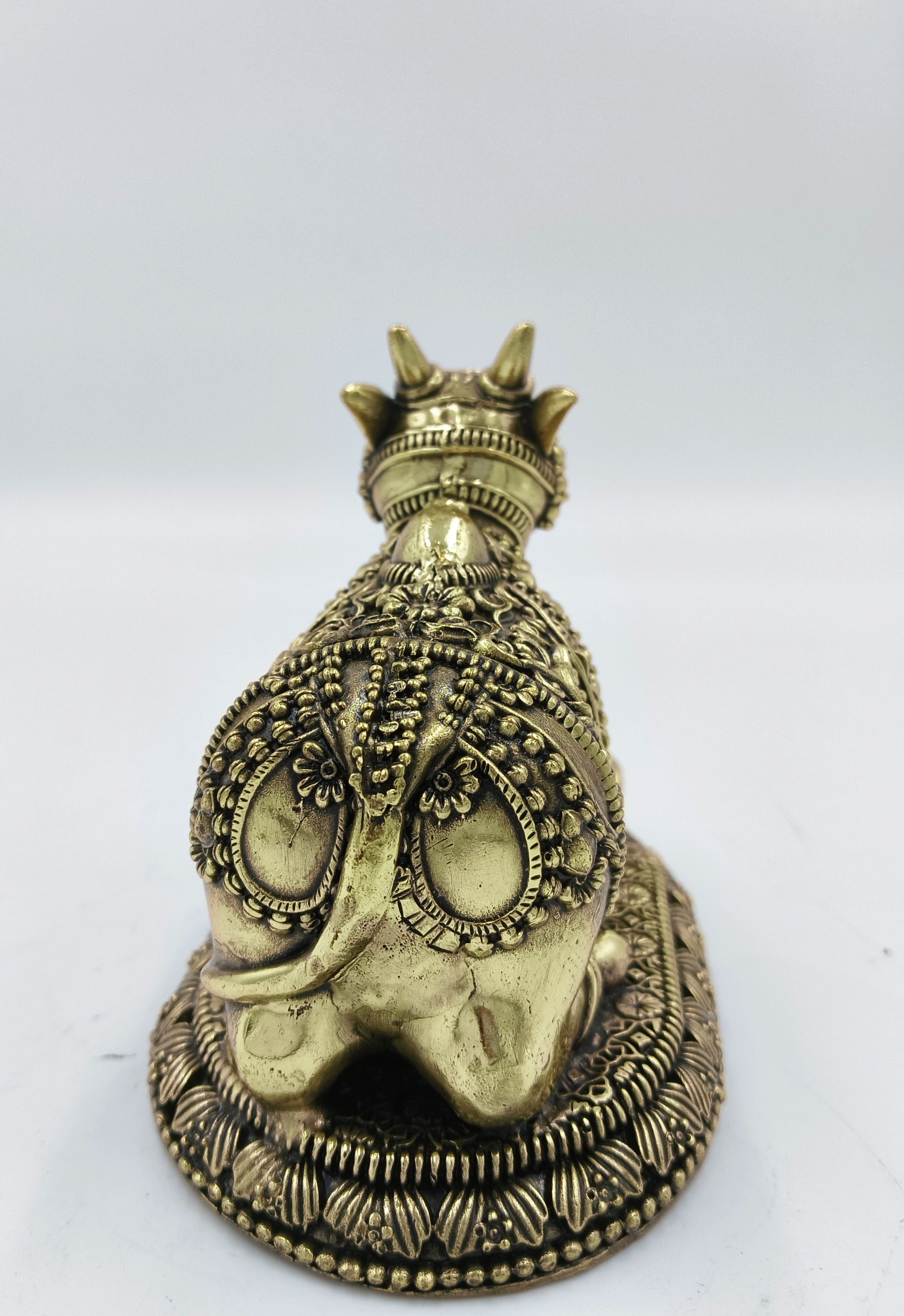 Back view of small brass Nandikeshwara sculpture with detailed decorations
