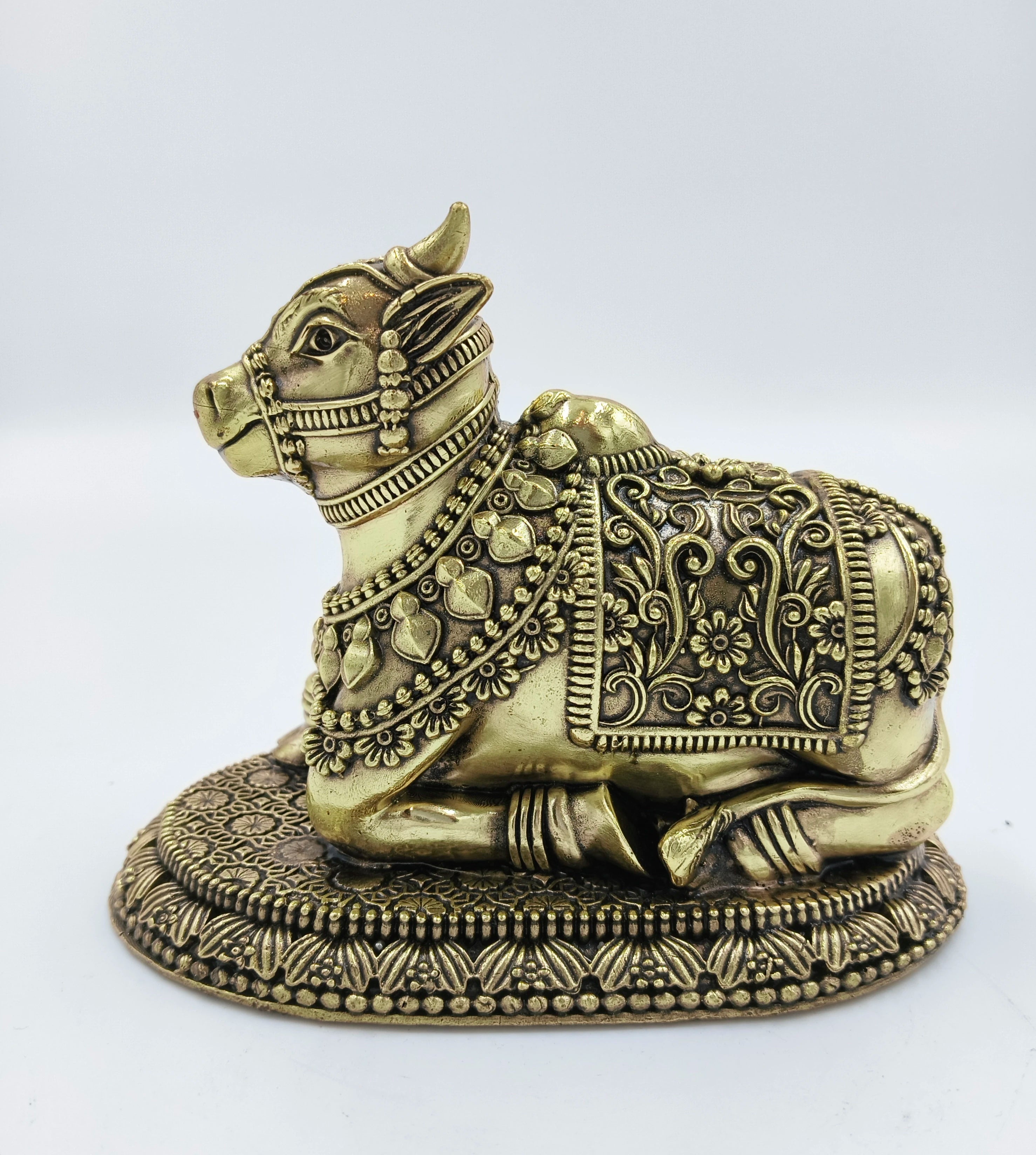 Brass Nandikeshwara sculpture with detailed floral and leaf engravings