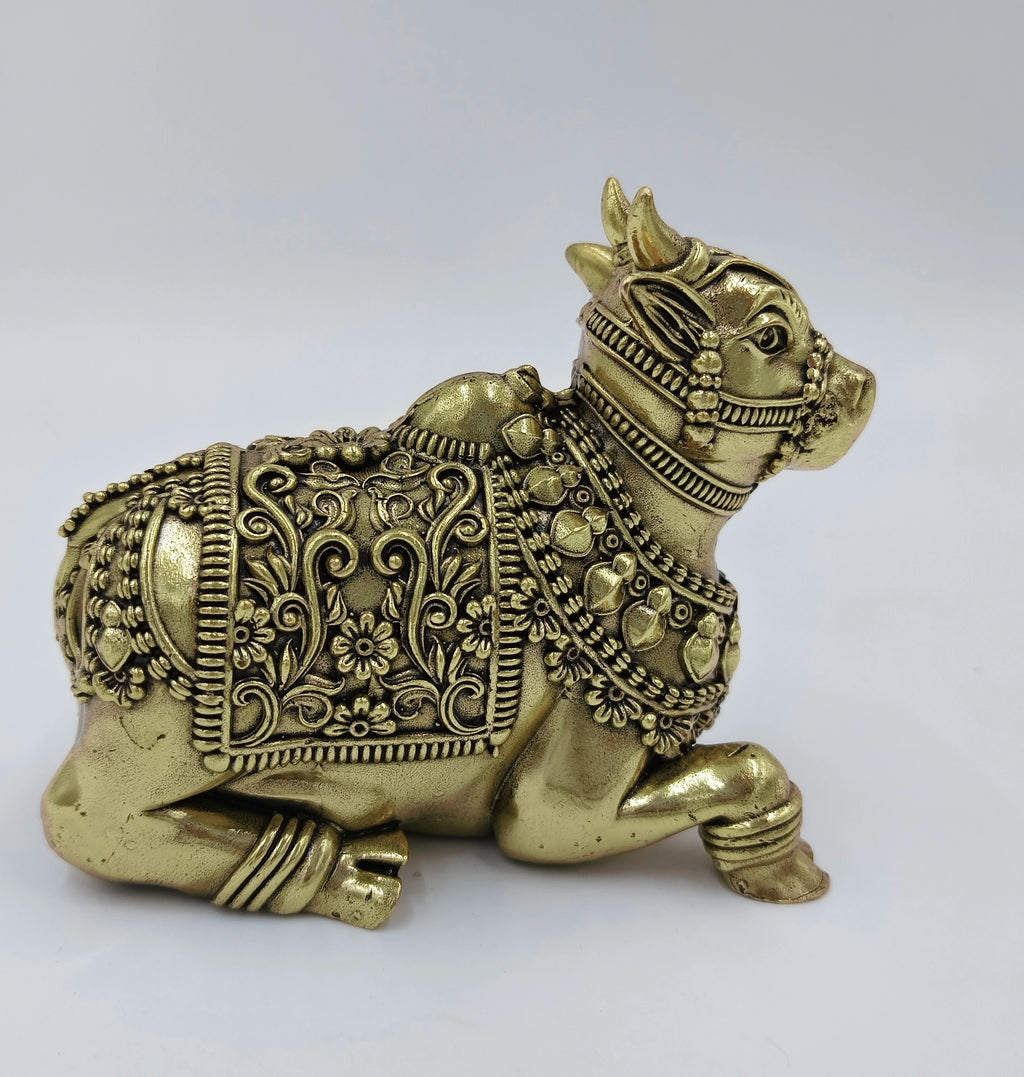 Large brass Nandideva sculpture with intricate floral and bead details side view