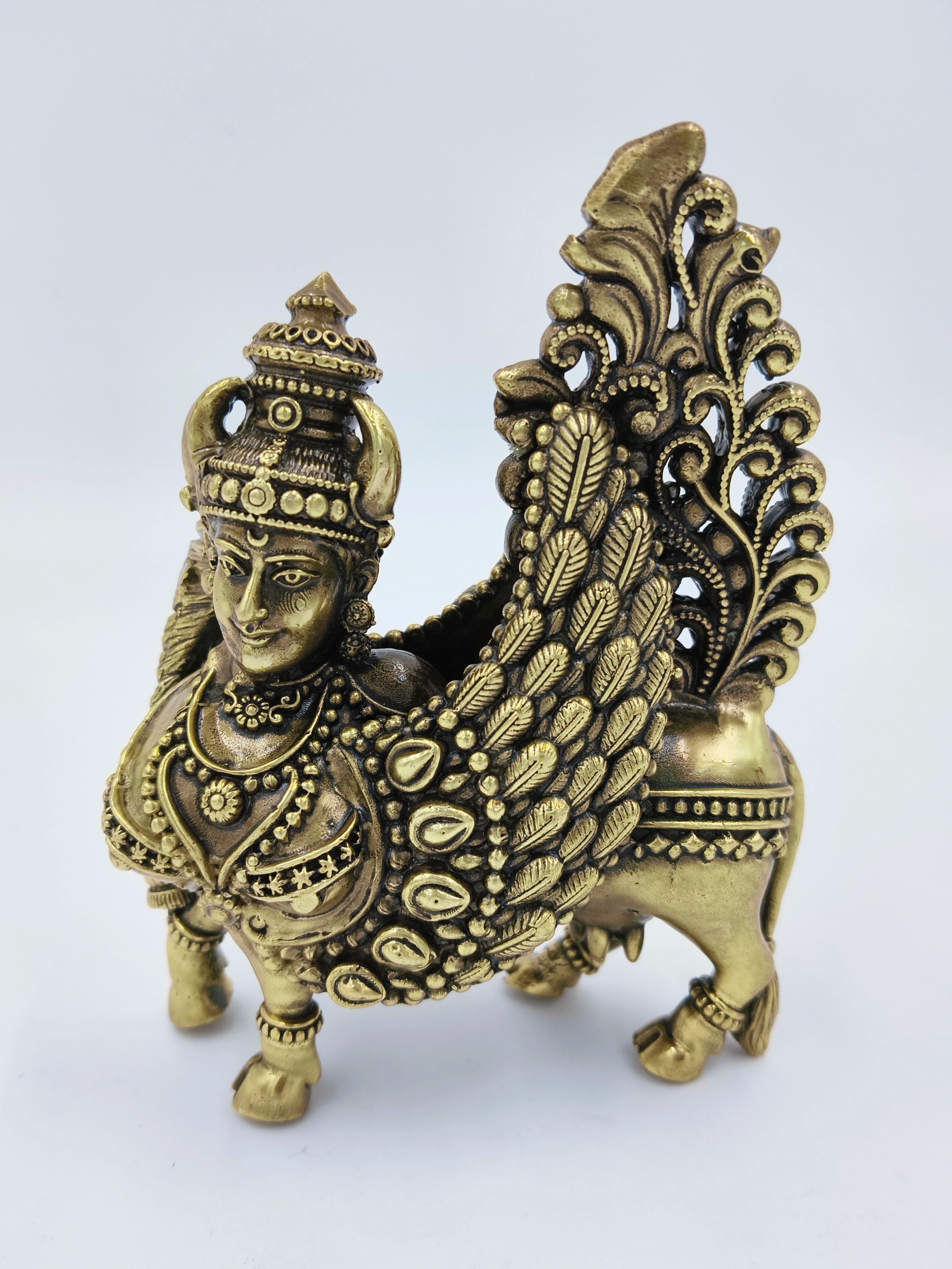 Brass Kamadhenu figurine with ornate detailing and wings, front side view