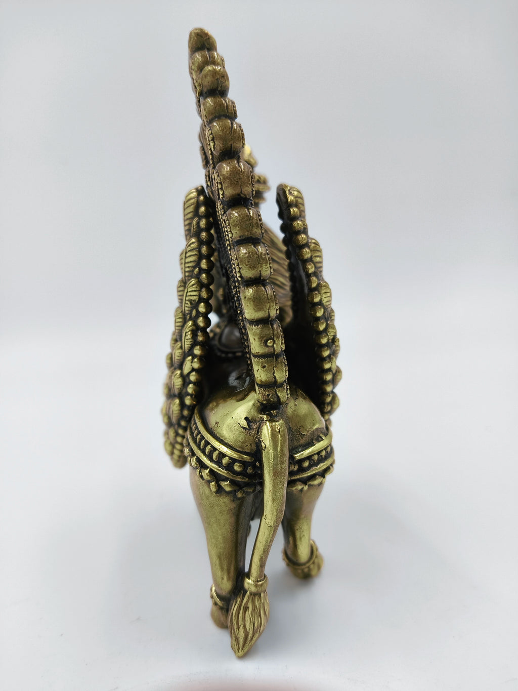 Rear view of medium brass Kamadhenu sculpture with detailed tail and ornamentation