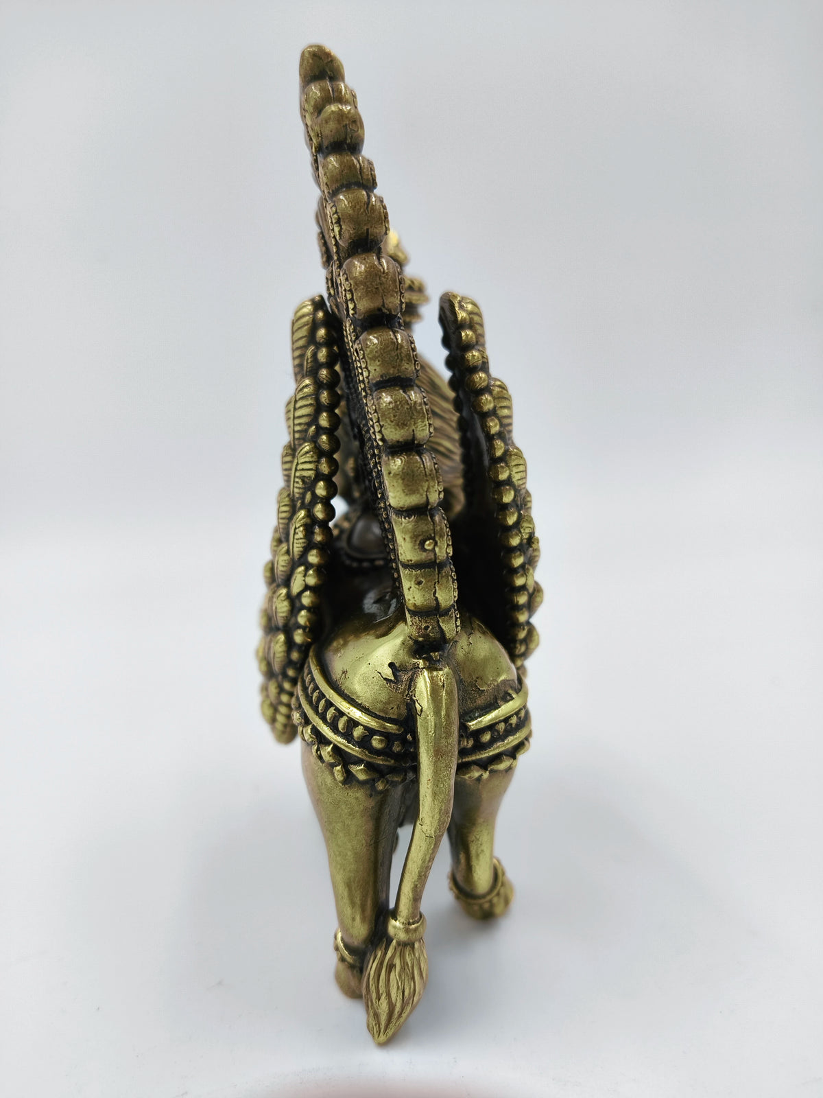 Rear view of medium brass Kamadhenu sculpture with detailed tail and ornamentation
