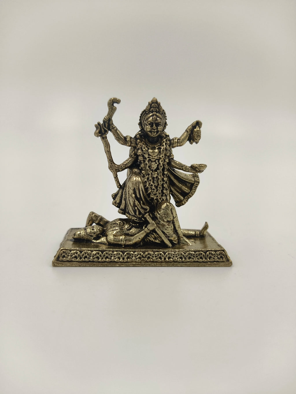 Mini brass statue of Kalika deity with four arms standing on a figure