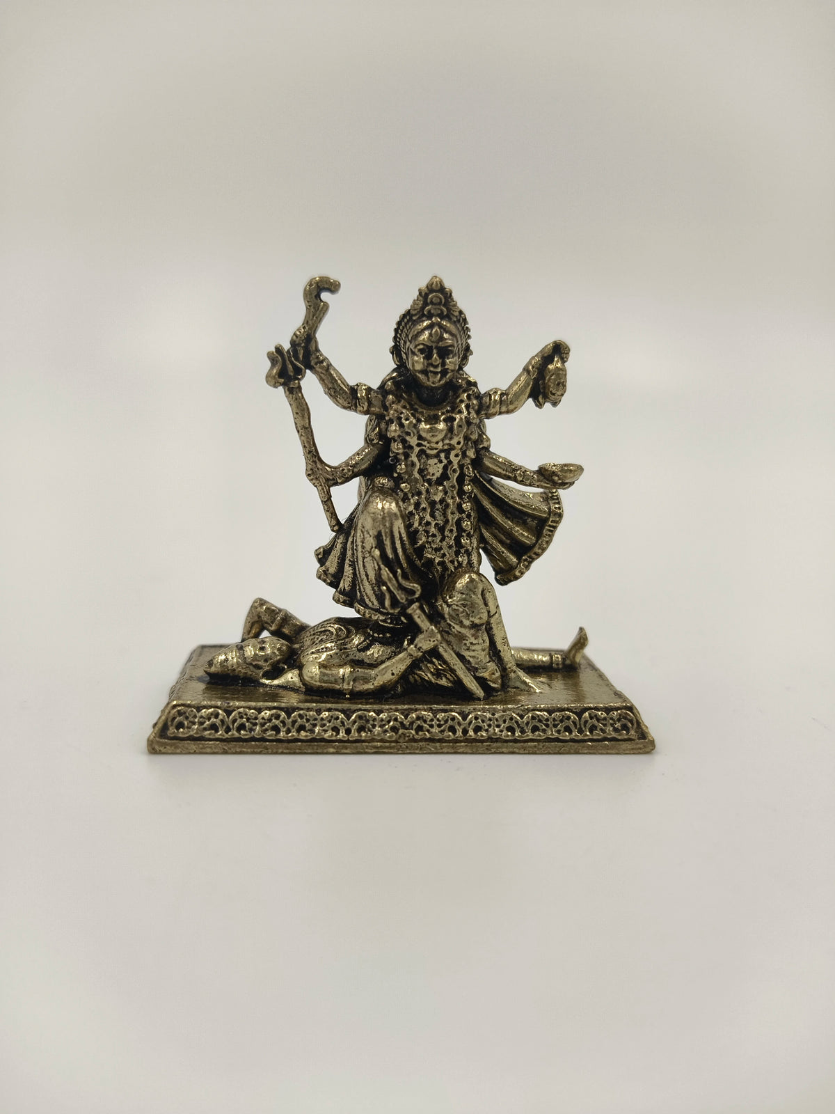 Mini brass statue of Kalika deity with four arms standing on a figure