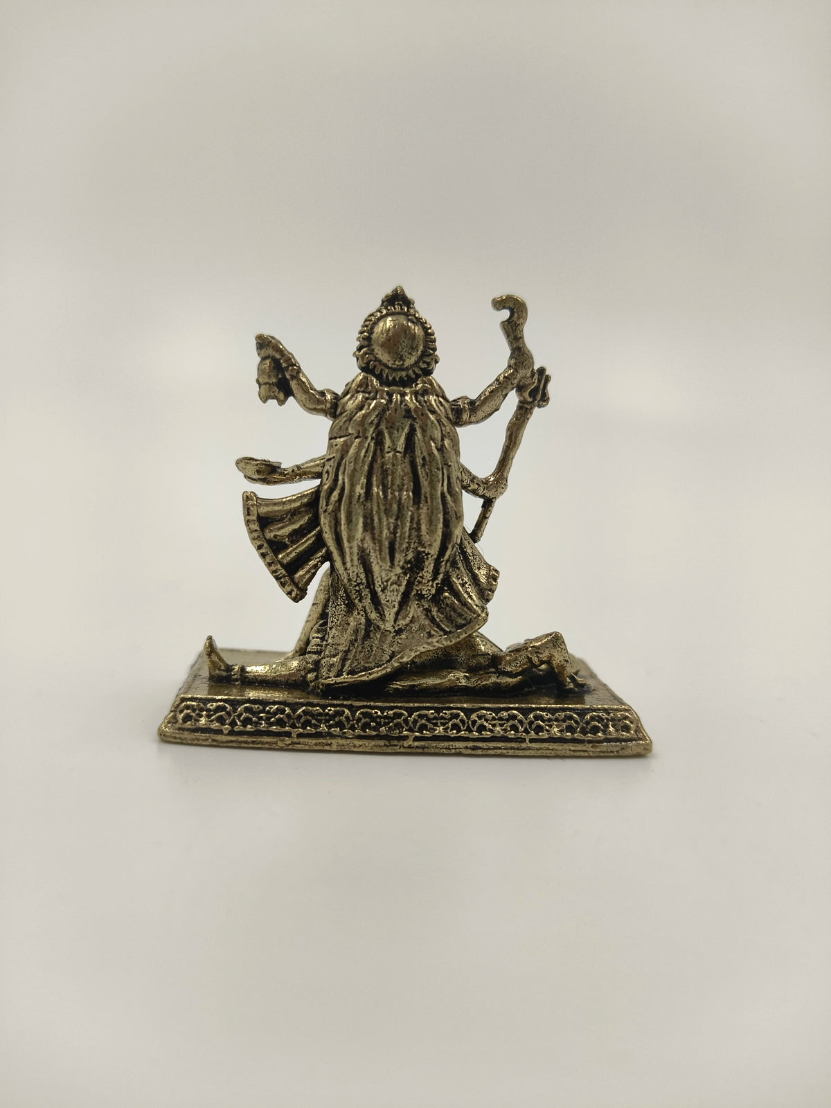 Back view of small brass Kalika deity sculpture on rectangular base