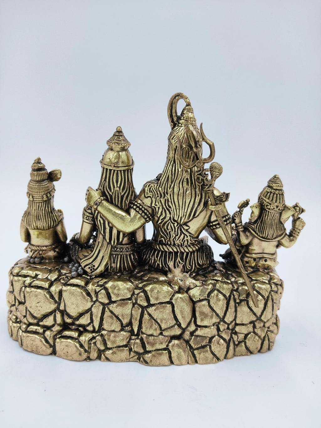 Back view of brass sculpture depicting Shiva and family seated on stone base