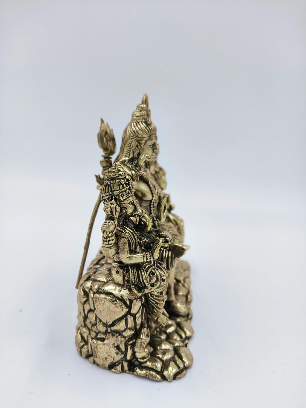 Side view of brass Shiv Parivar sculpture with Shiva, Parvati, and Ganesha seated