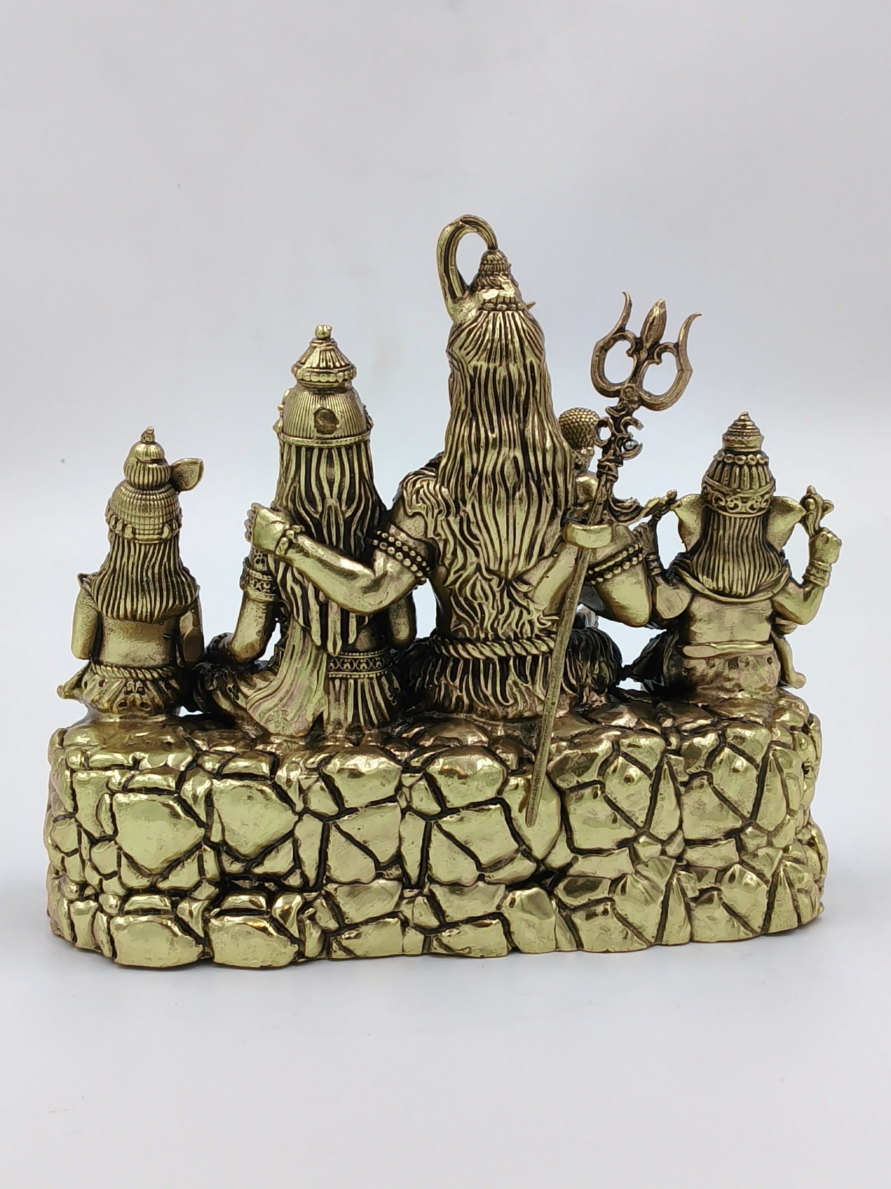 Back view of brass Shiv Parivar sculpture showing Shiva with family seated on stone base