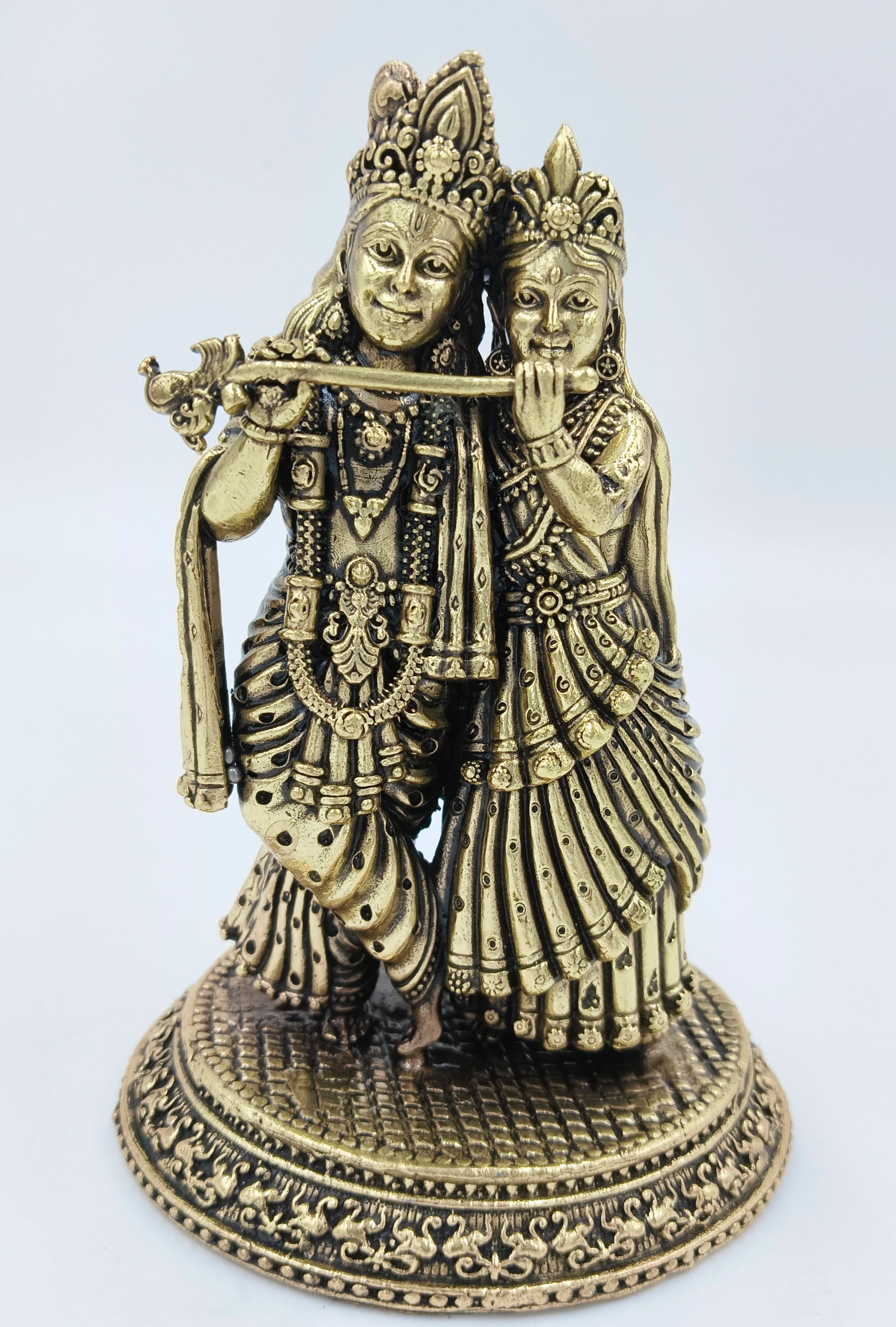 Decorative brass sculpture of Radhakrishna standing on ornate base