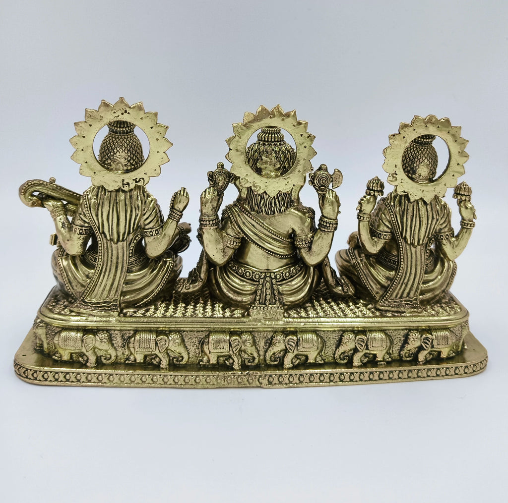 Back view of brass Trayi Ashirwad statue featuring Lakshmi, Ganesh, and Saraswathi