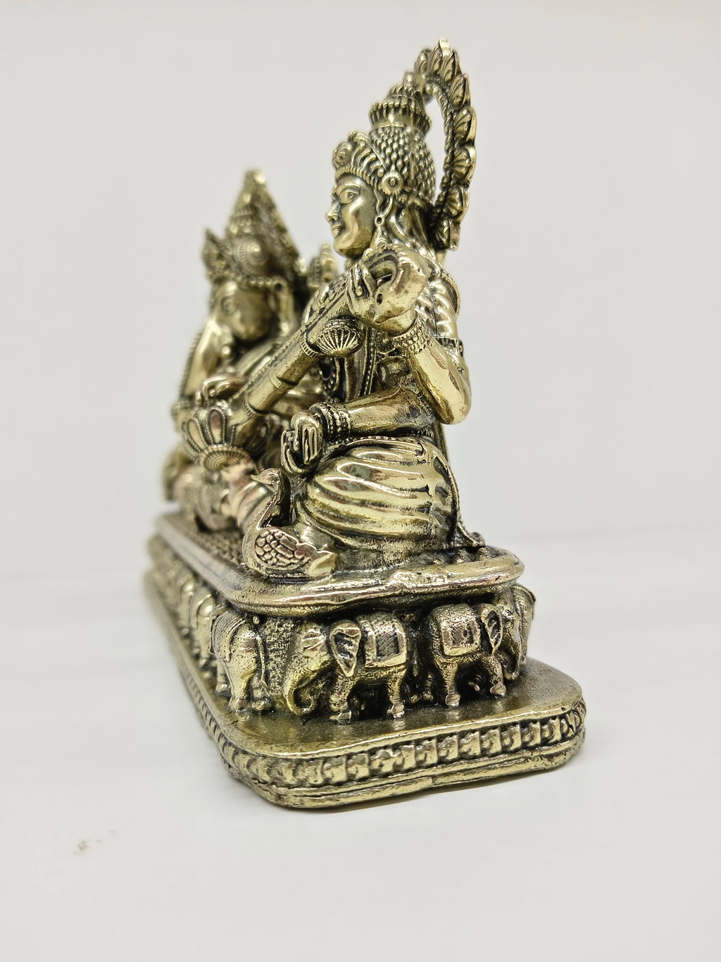 Small brass Trayi Ashirwad statue depicting Lakshmi, Ganesh, and Saraswathi side view