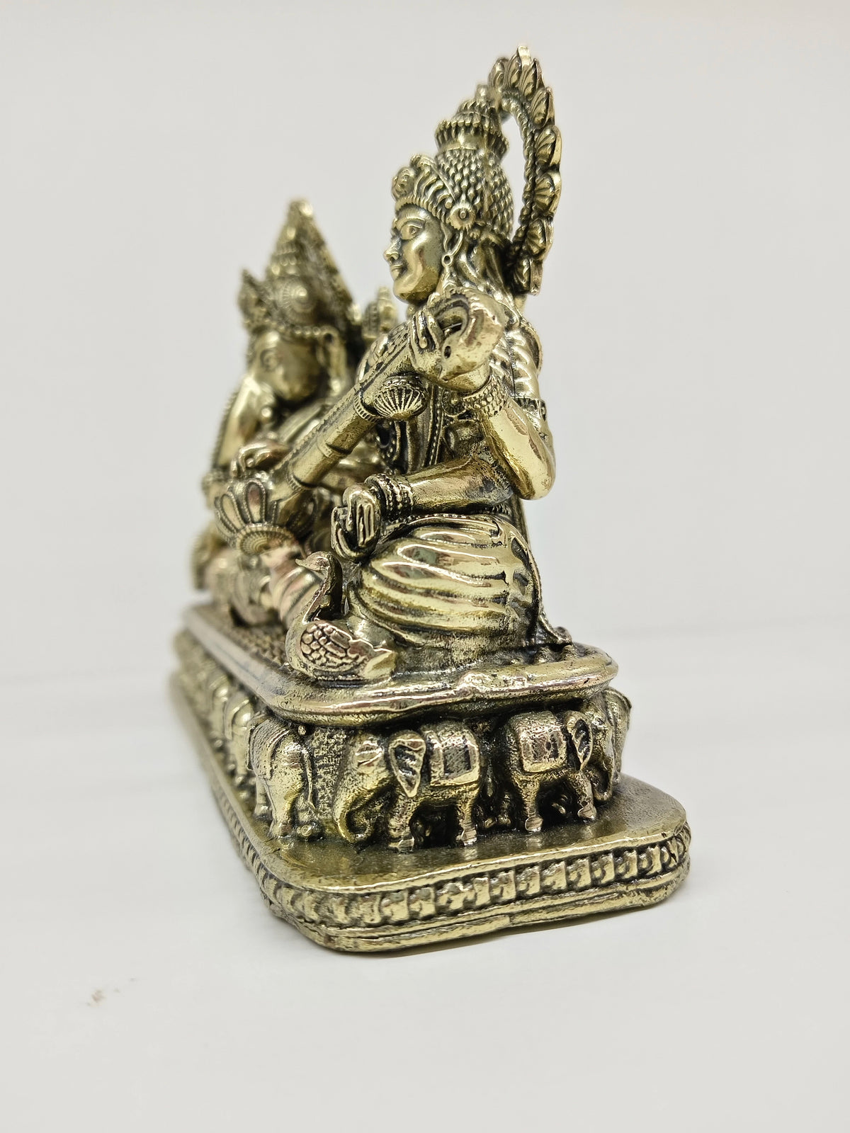 Small brass Trayi Ashirwad statue depicting Lakshmi, Ganesh, and Saraswathi side view