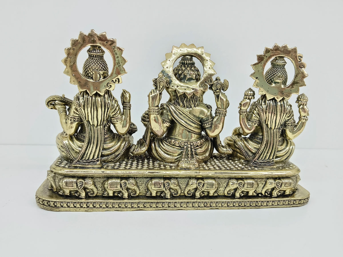 Back view of small brass Trayi Ashirwad statue with Lakshmi, Ganesh, and Saraswathi