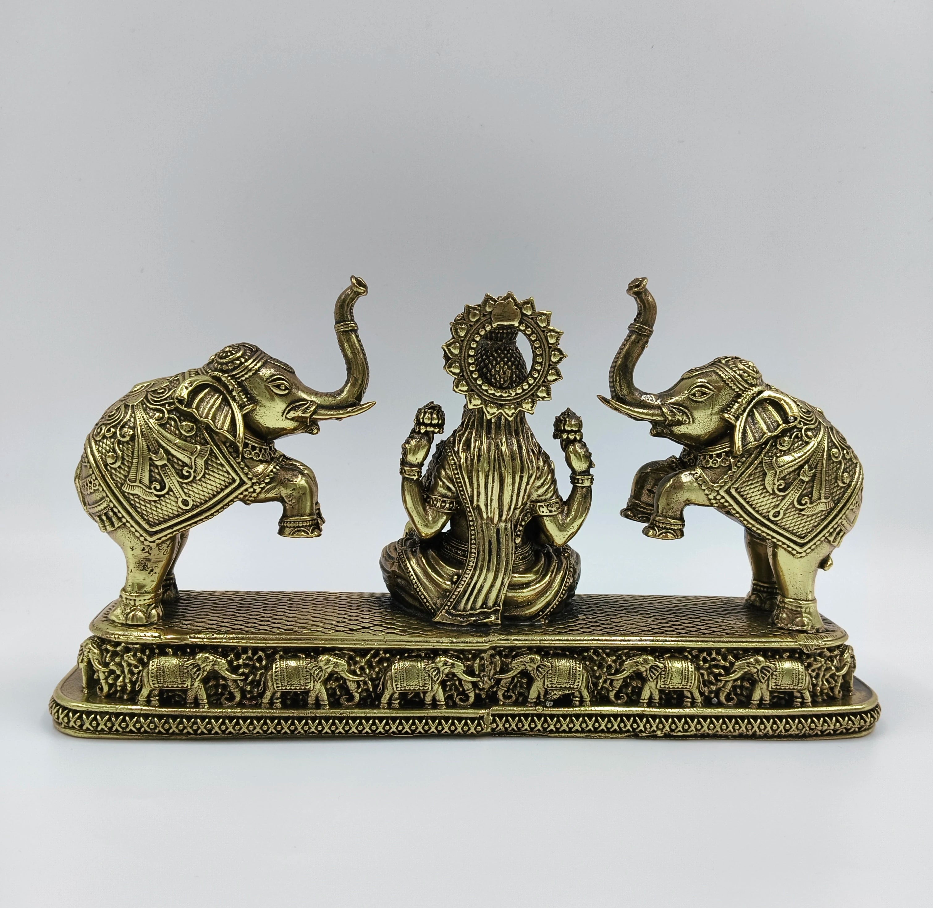 Back view of medium brass Gajalakshmi sculpture with elephants on detailed base