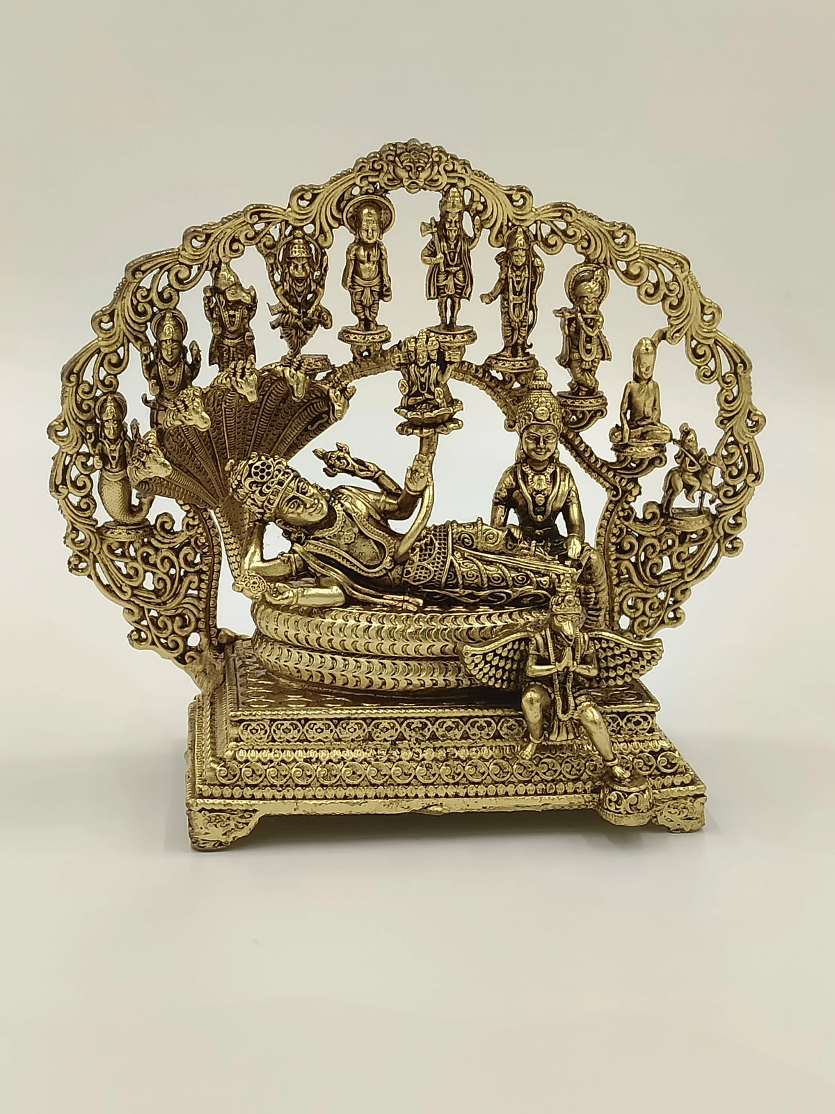 Medium brass Vishnu Lakshmi sculpture with detailed arch and multiple figures