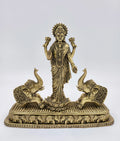 Large brass standing Gajalakshmi statue with two decorative elephants on rectangular base