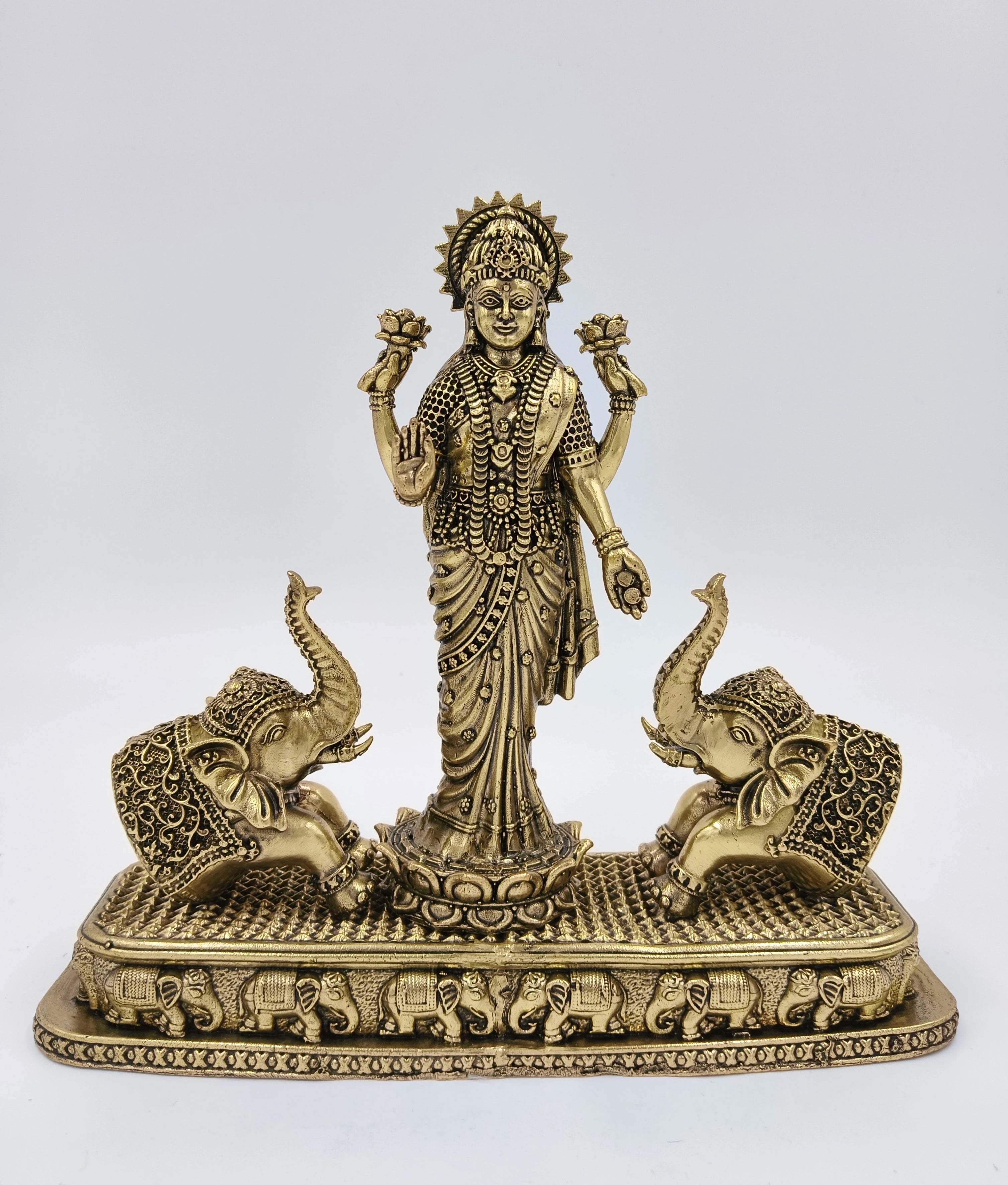 Large brass standing Gajalakshmi statue with two decorative elephants on rectangular base