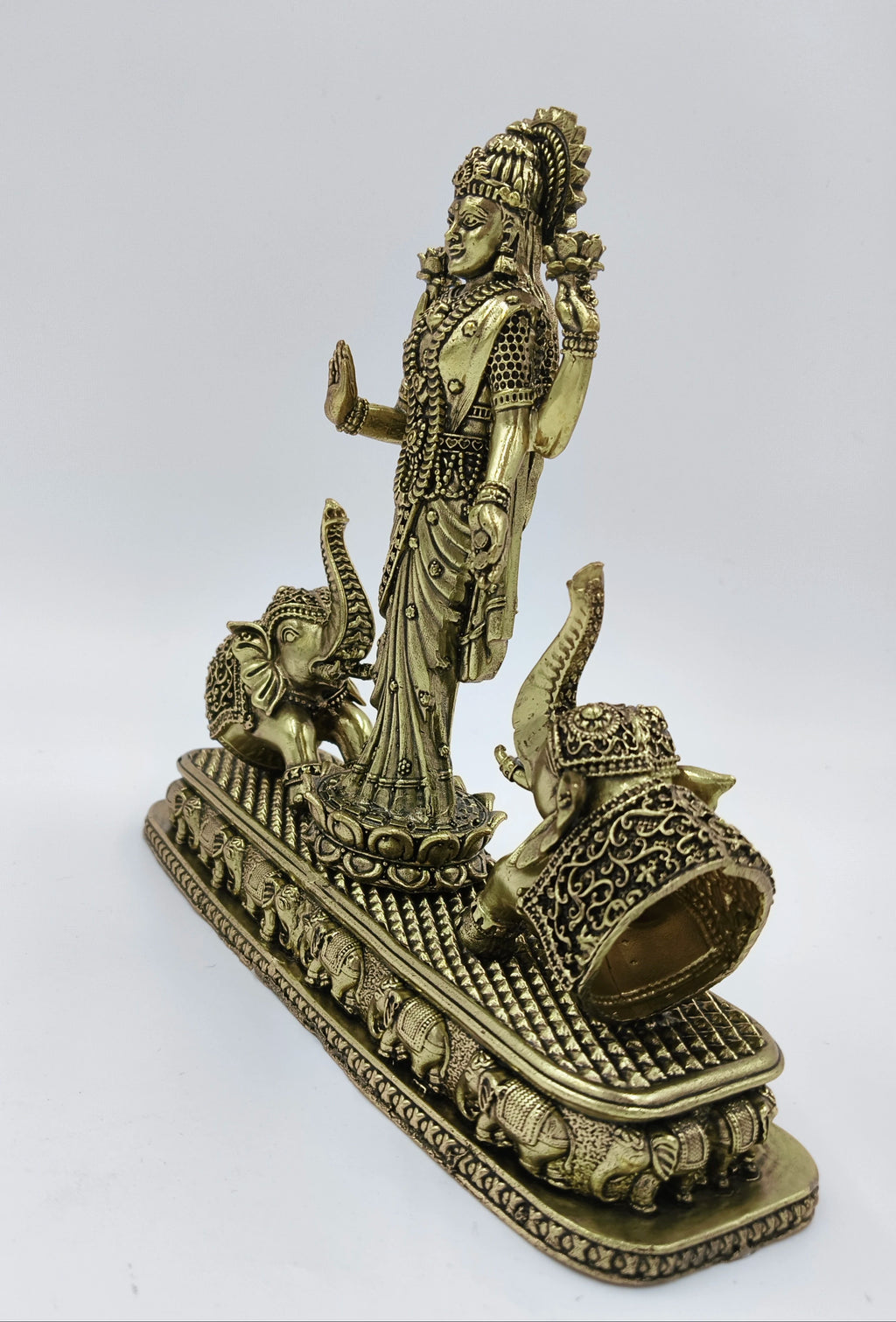 Brass standing statue of goddess Lakshmi with two elephants on a decorated base