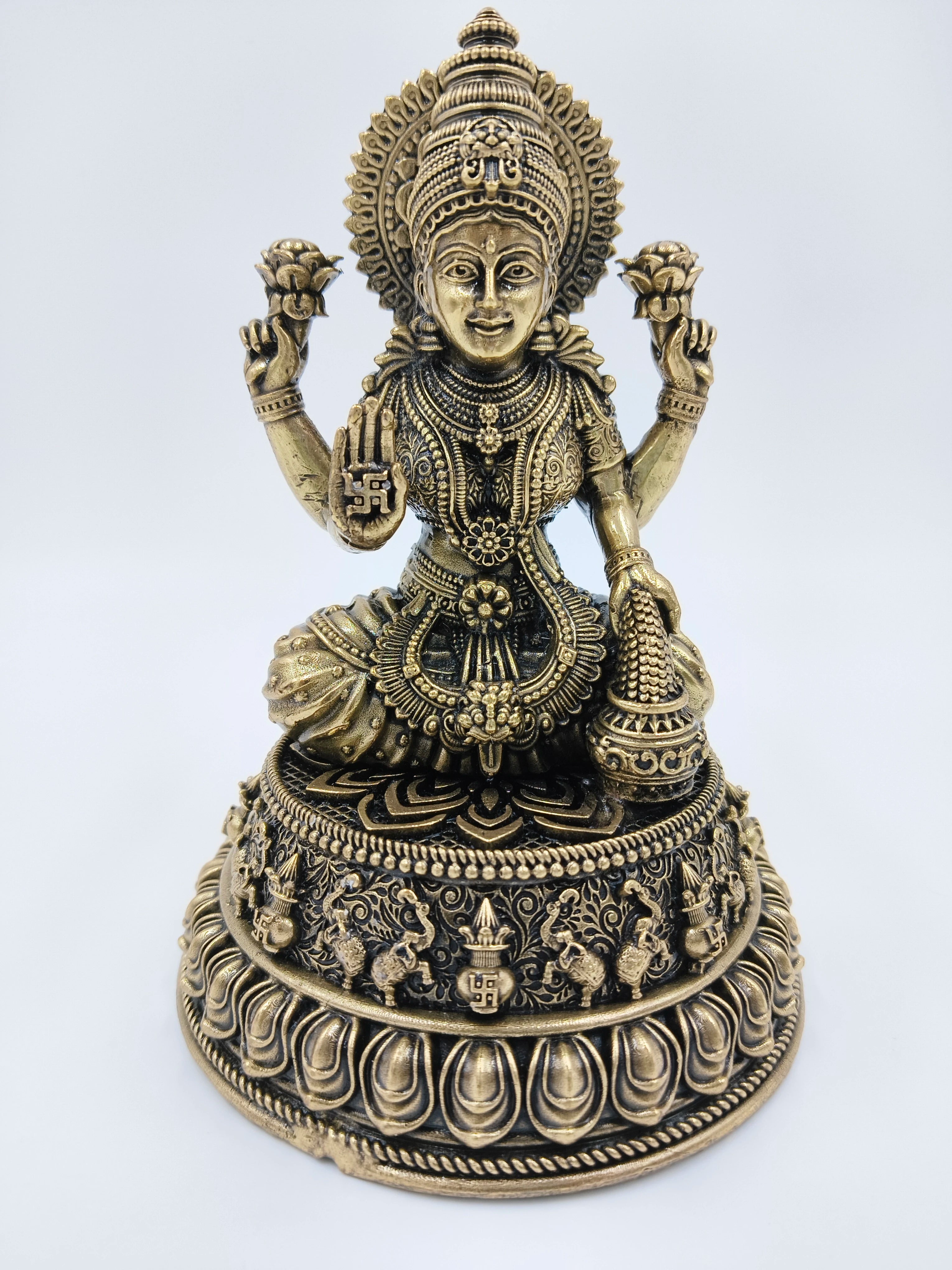 Medium brass statue of Goddess Lakshmi seated on an ornate lotus pedestal