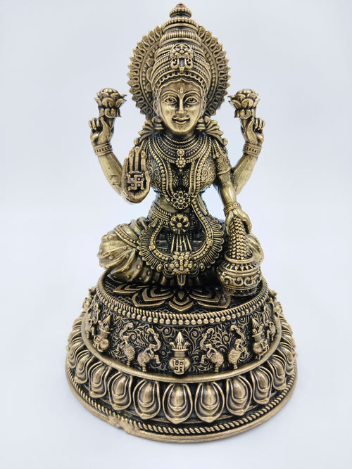 Medium brass statue of Goddess Lakshmi seated on an ornate lotus pedestal