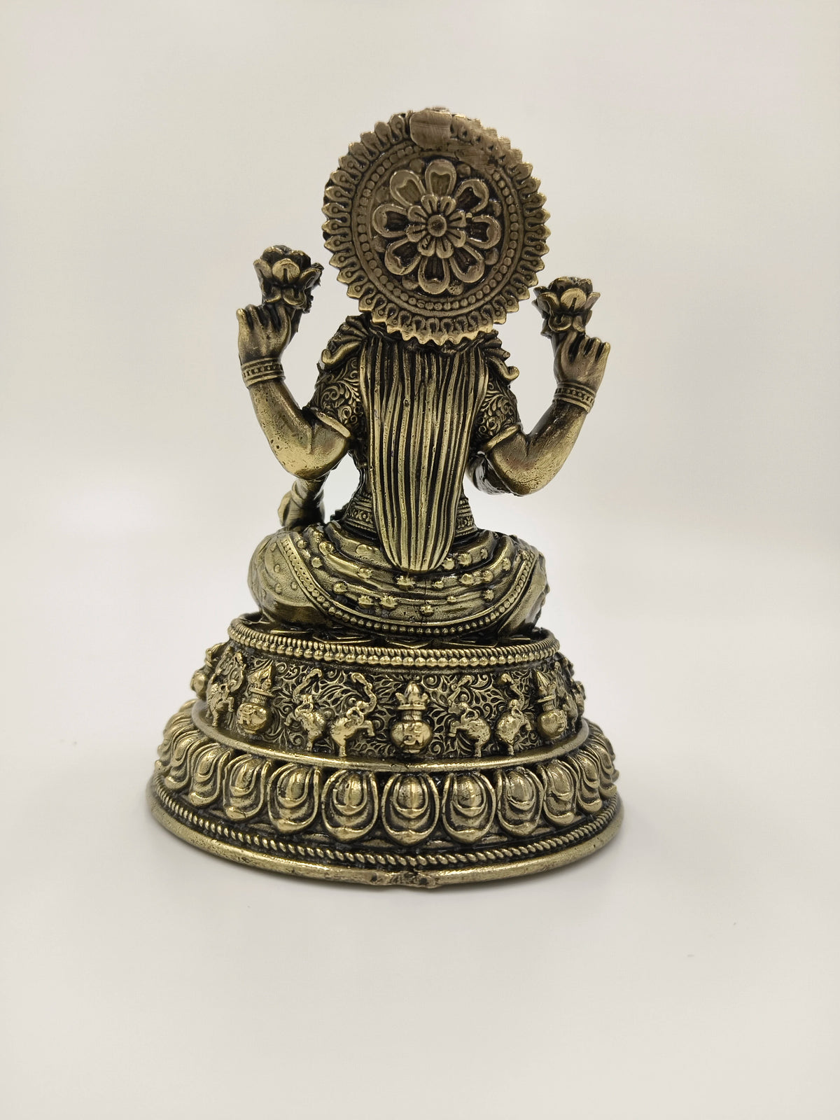 Brass Padmini sculpture of goddess Lakshmi seated with intricate detailing, back view