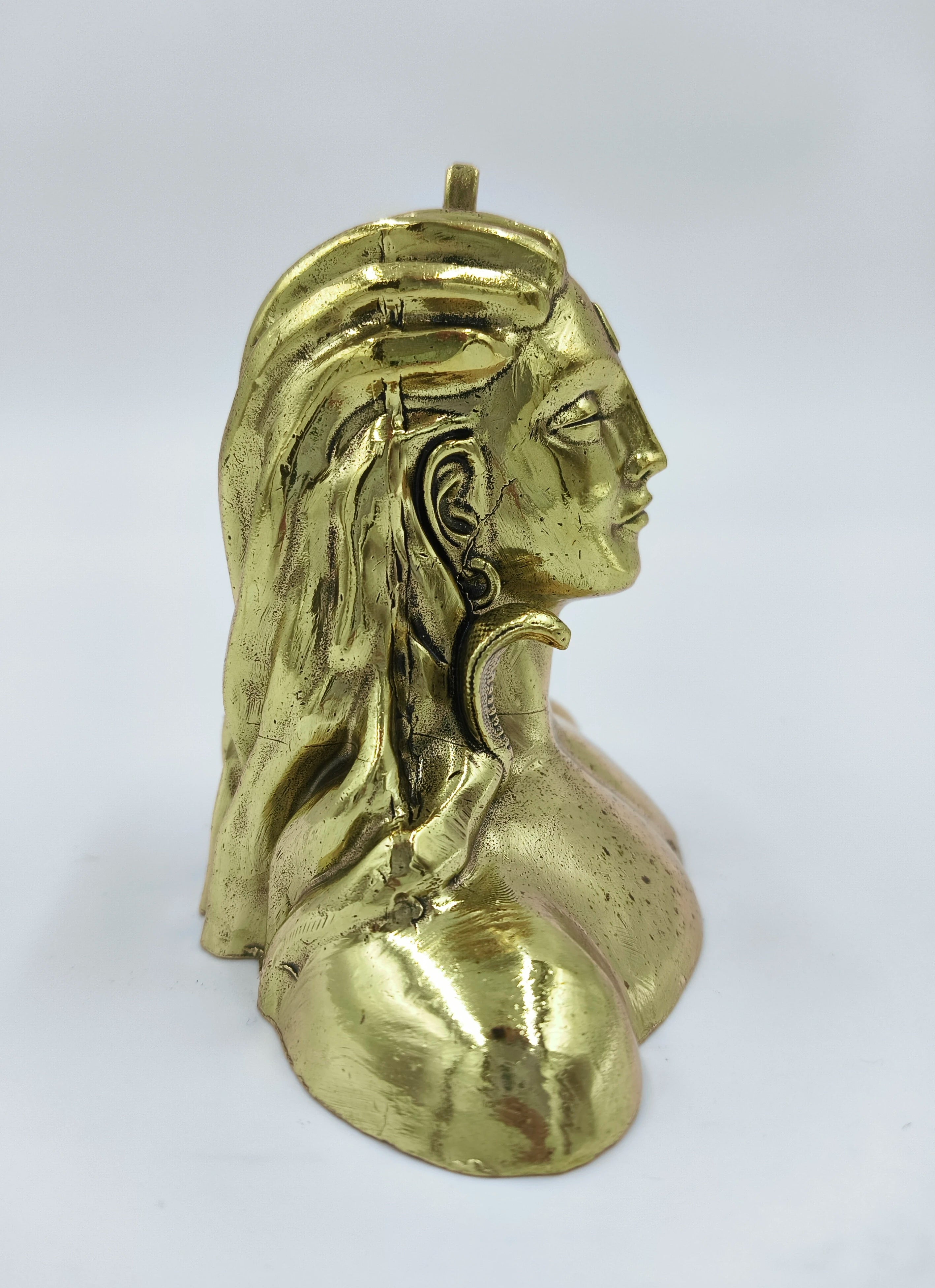 Side view of small brass Adiyogi Shiva sculpture with detailed hair and face