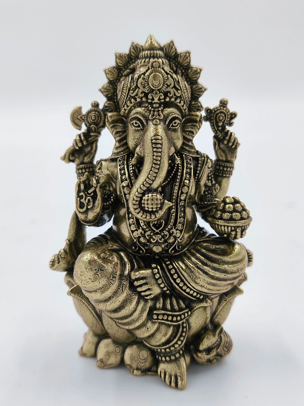 Mini brass statue of Hindu deity Ganesh with intricate detailing