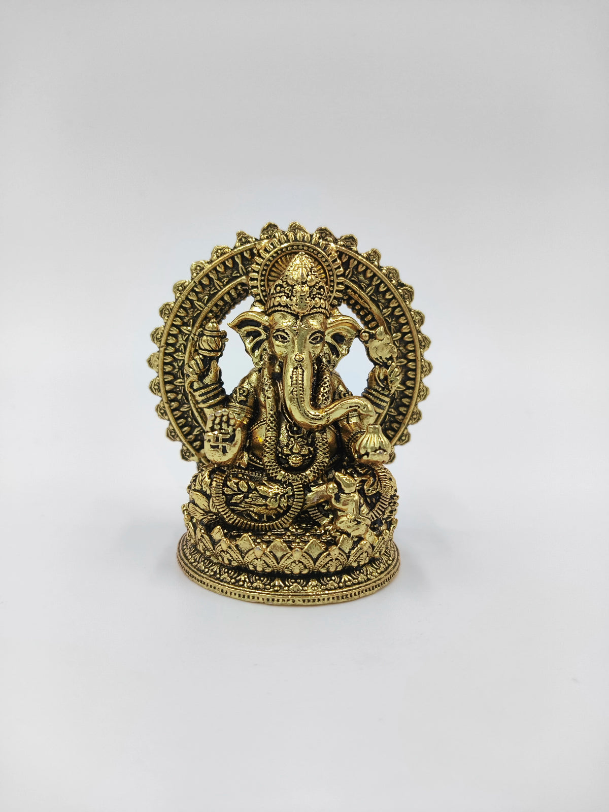 Mini brass Prabhavali statue of Hindu deity Ganesh with intricate detailing