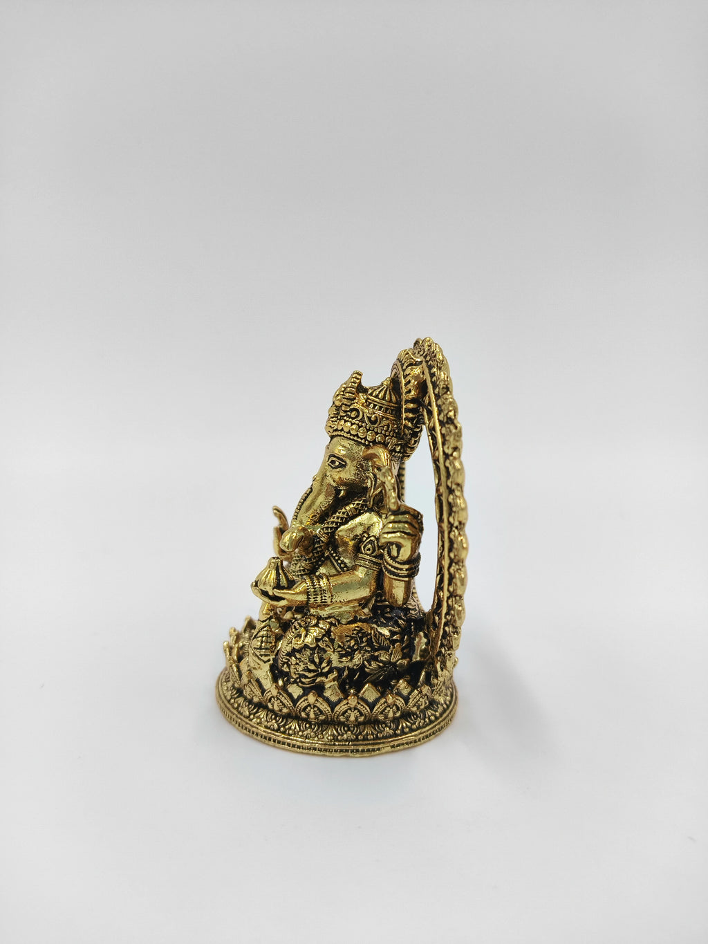 Mini brass Prabhavali Ganesh statue with detailed floral base and arch
