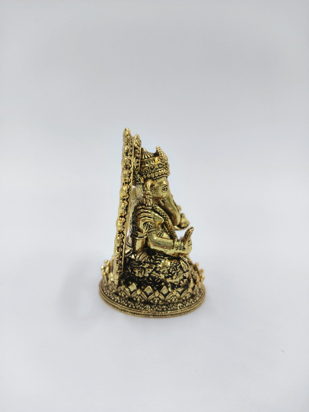 Side view of mini brass Prabhavali Ganesh statue with detailed carvings