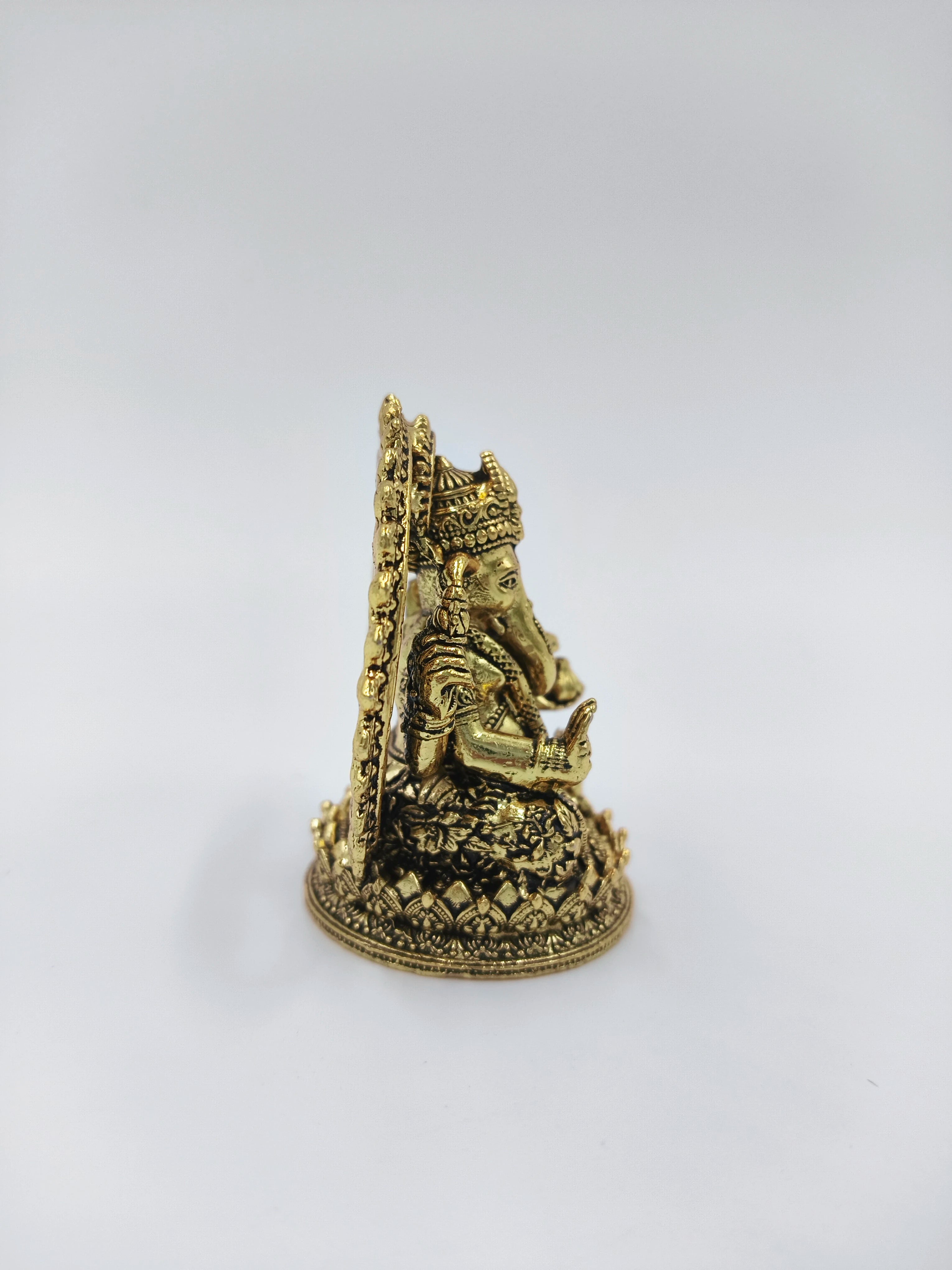 Side view of mini brass Prabhavali Ganesh statue with detailed carvings