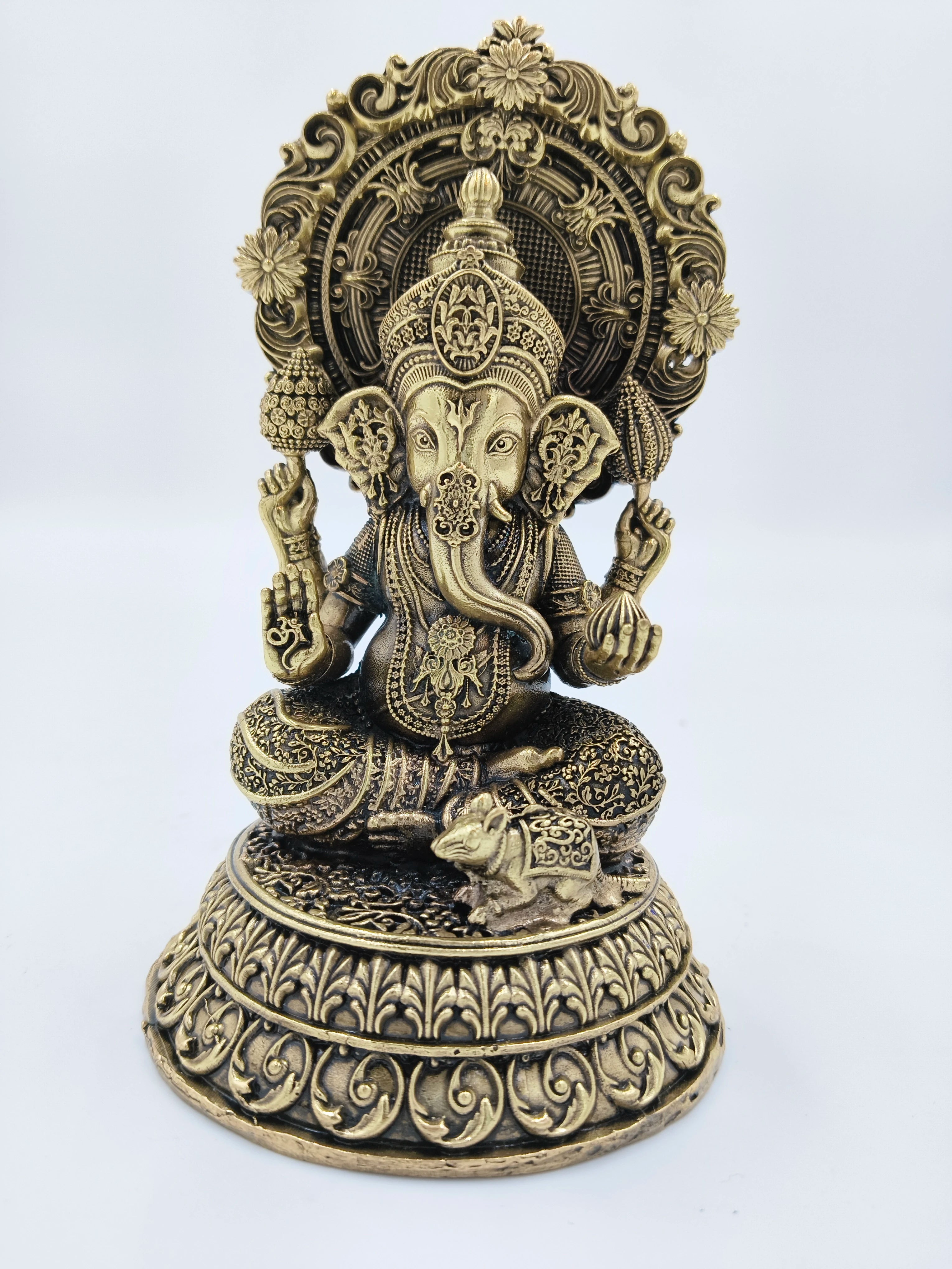 Medium brass statue of seated Ganesh with ornate floral detailing and mouse