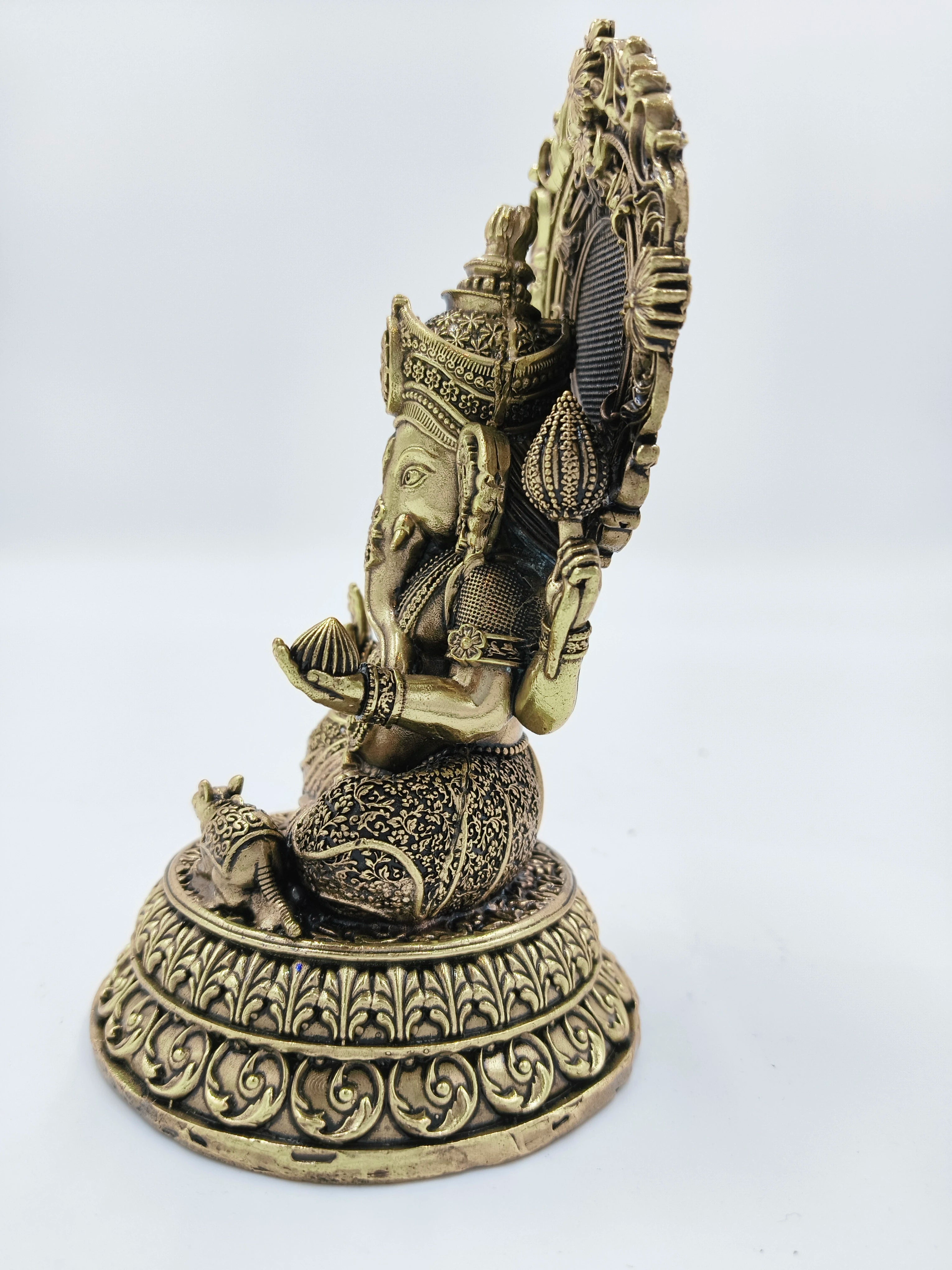 Side view of medium brass Gajanana Ganesh statue with detailed ornamental base