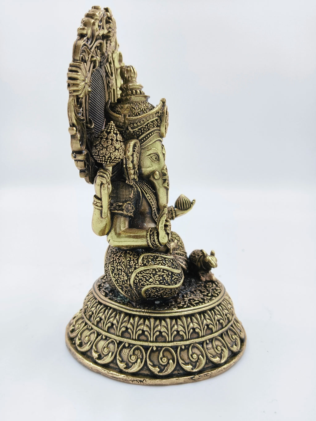 Side view of medium brass Ganesha sculpture with detailed ornamentation