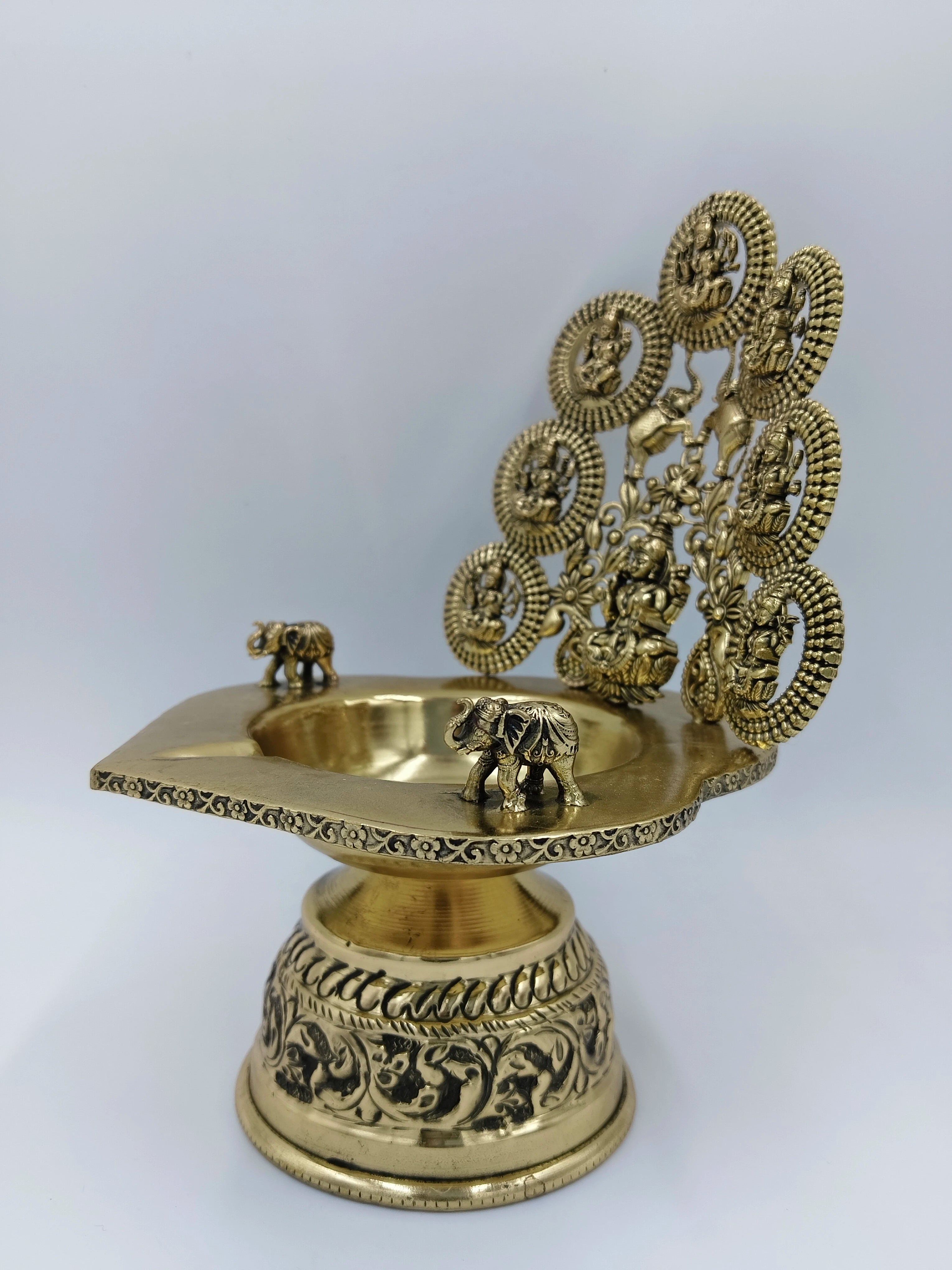Brass Astalakshmi lamp with detailed deity figures and decorative elephants